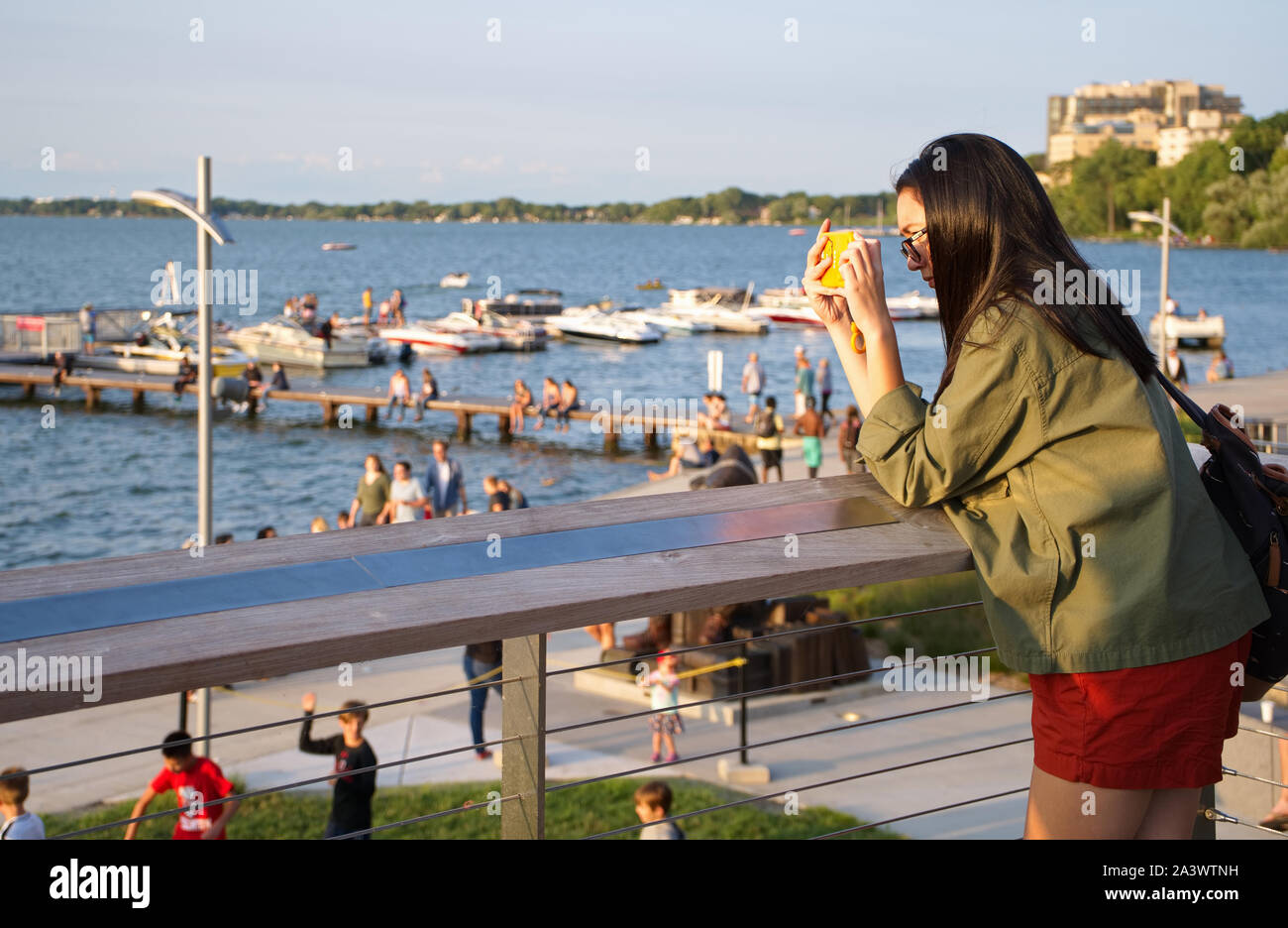 Madison, WI USA. Jul 2018.Young visitor taking cellphone pictures at the Alumni Park view deck. Stock Photo