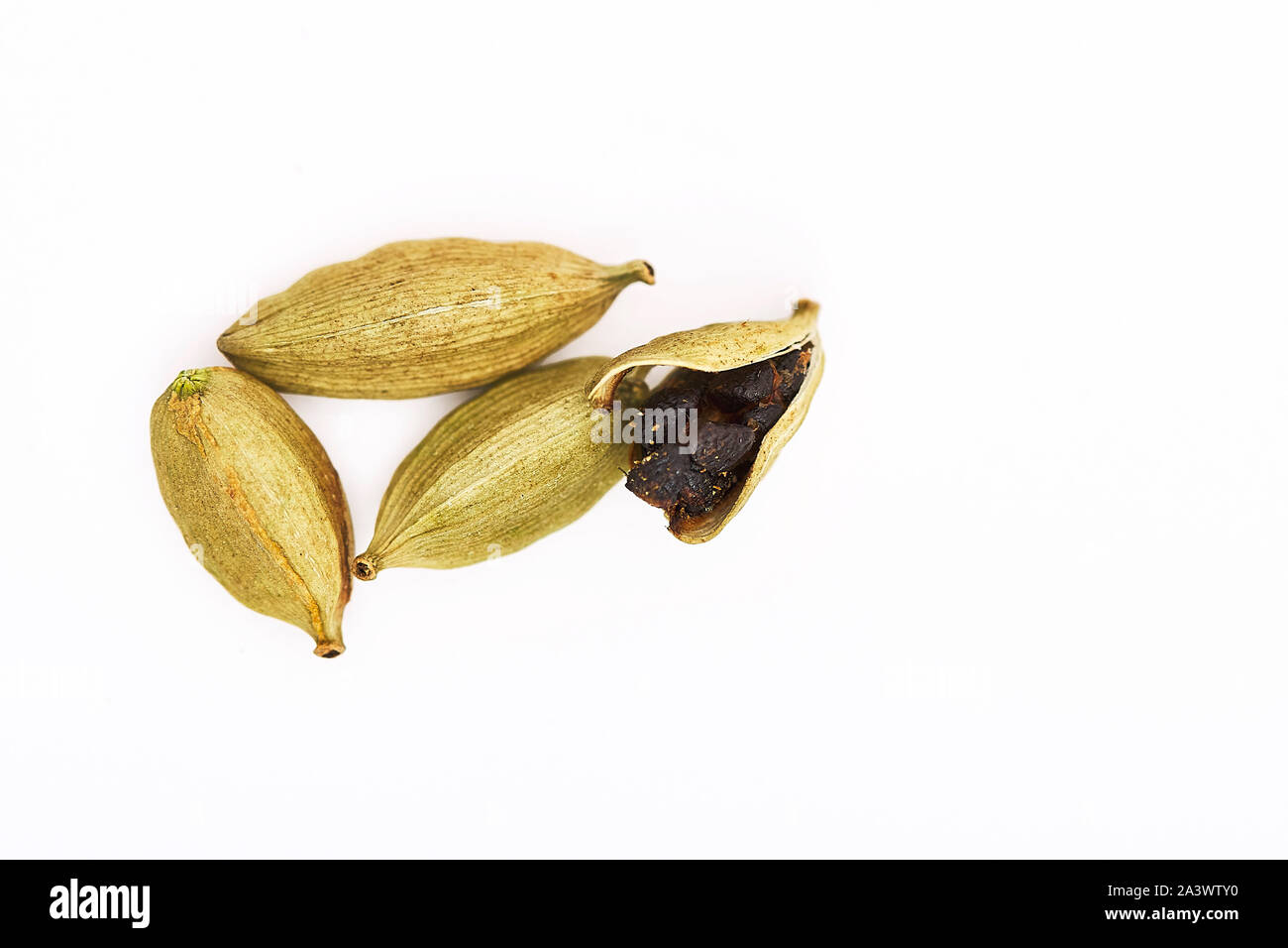 Whole Green Cardamom pods and open pod with seeds on a white background