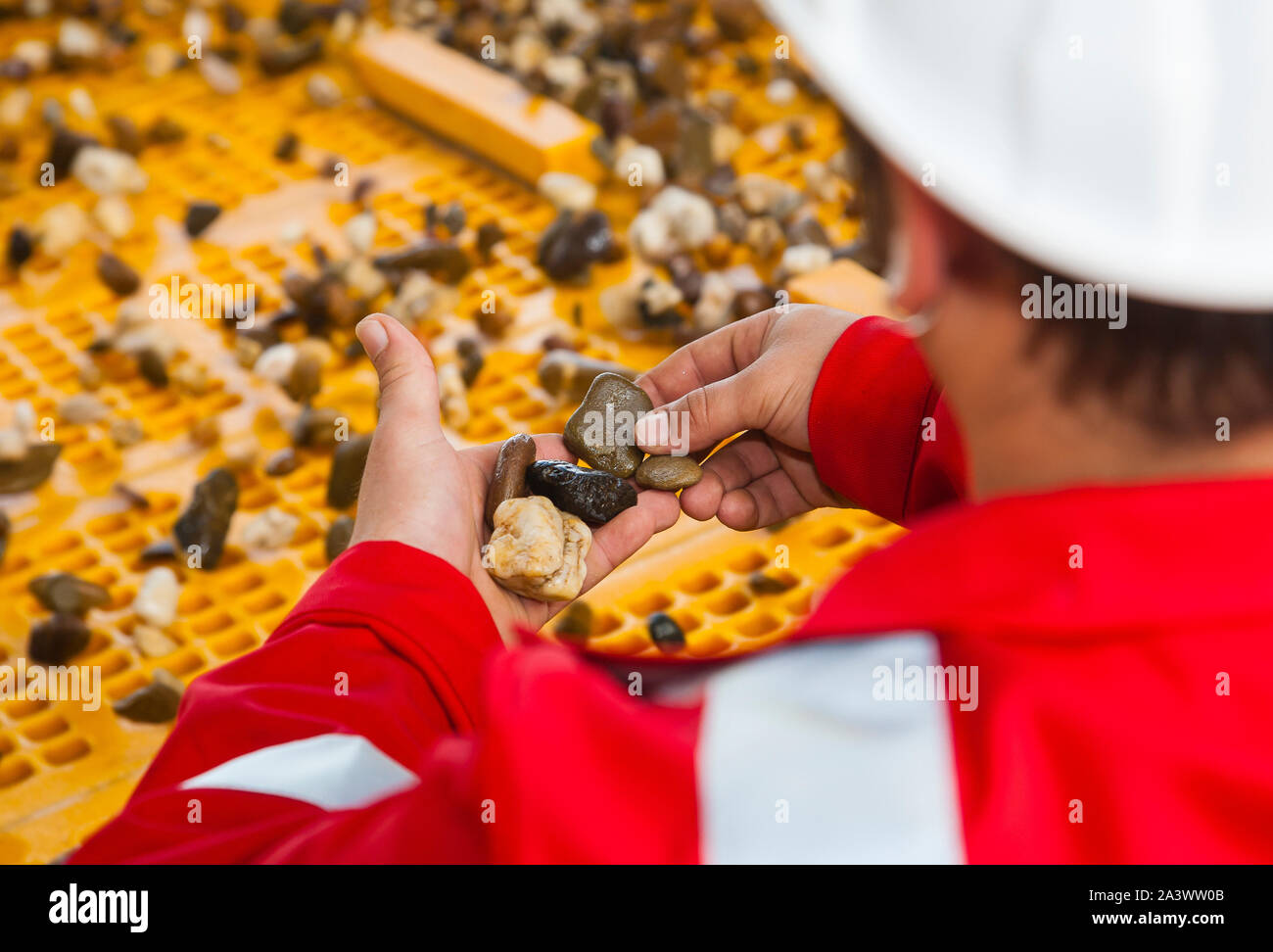 Voerde, Lower Rhine, North Rhine-Westphalia, Germany - Gravel plant, a processing mechanic monitoring the processing plant, here quality control on th Stock Photo