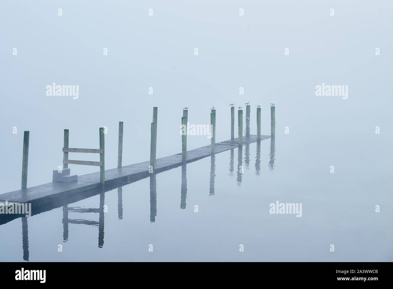 Morning mist over a jetty at Lake Derwentwater, Lake District, Cumbria, England. Stock Photo