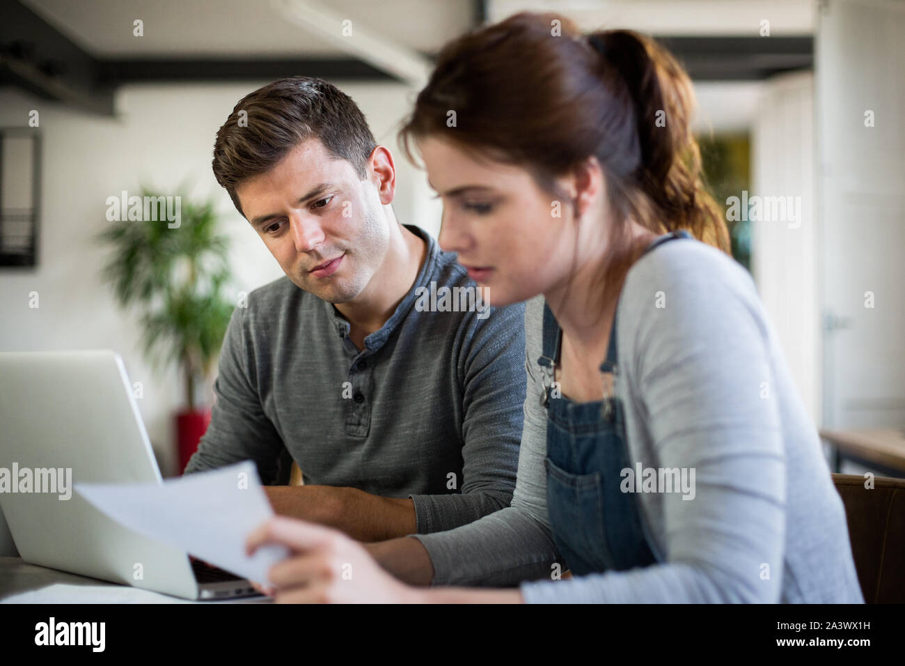Young adult couple working on finance application together Stock Photo