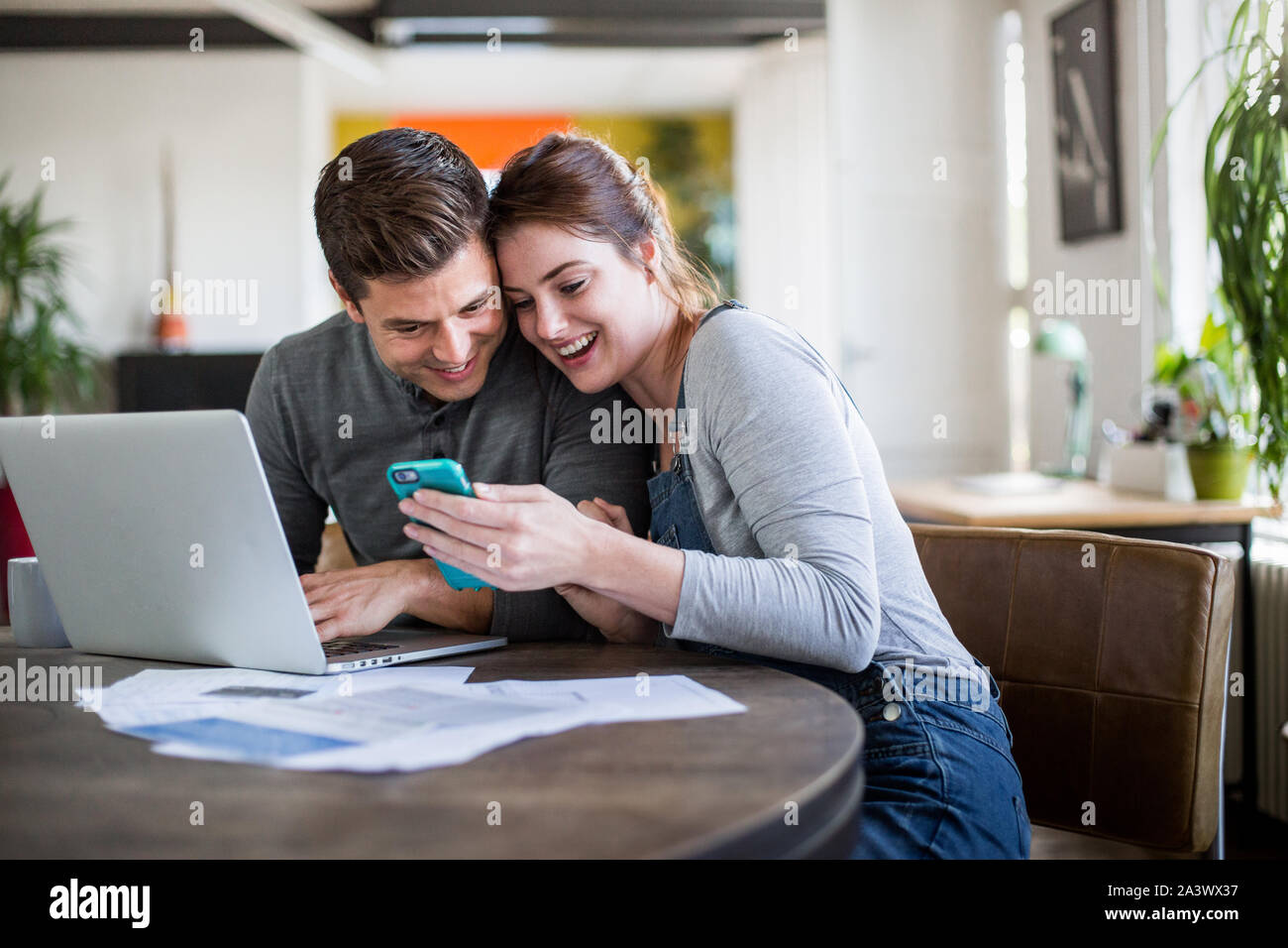 Young adult couple celebrating getting a mortgage together Stock Photo