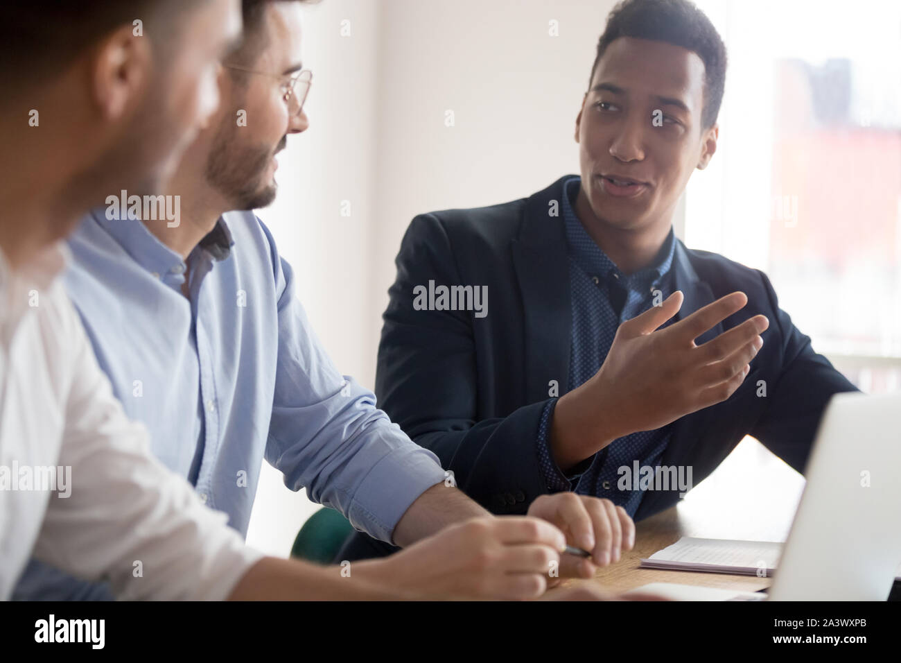 African american businessman offering idea at diverse team meeting Stock Photo
