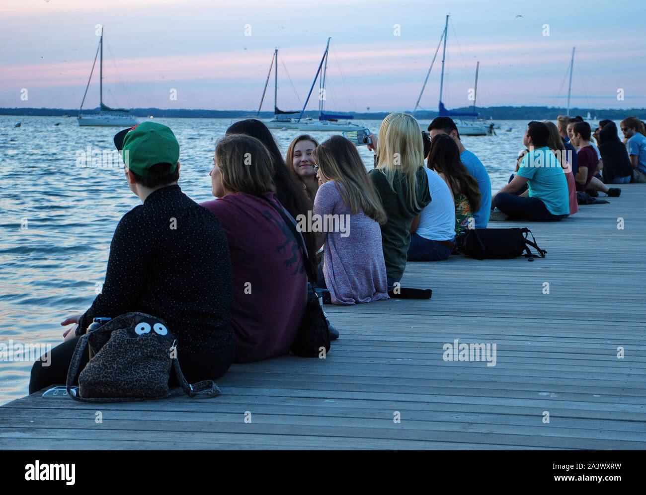 Madison, WI USA. Jul 2018. Students and visitors enjoying, eating, and waiting for the setting sun at the Alumni Park. Stock Photo