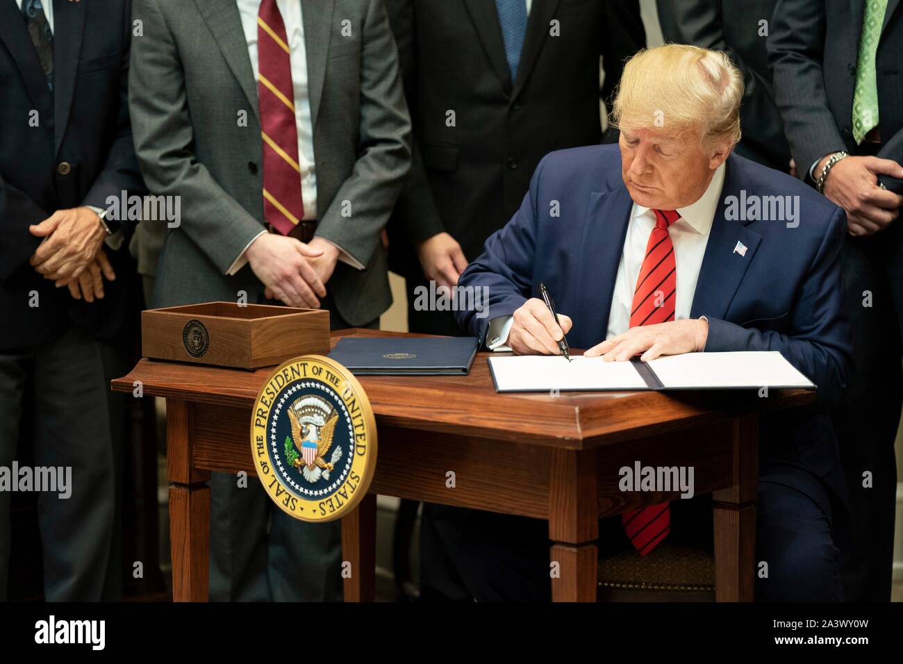 Washington, United States of America. 09 October, 2019. U.S President Donald Trump holds up the signed Executive Orders on Transparency in Federal Guidance and Enforcement during a ceremony in the Roosevelt Room of the White House October 9, 2019 in Washington, DC.  Credit: Shealah Craighead/White House Photo/Alamy Live News Stock Photo