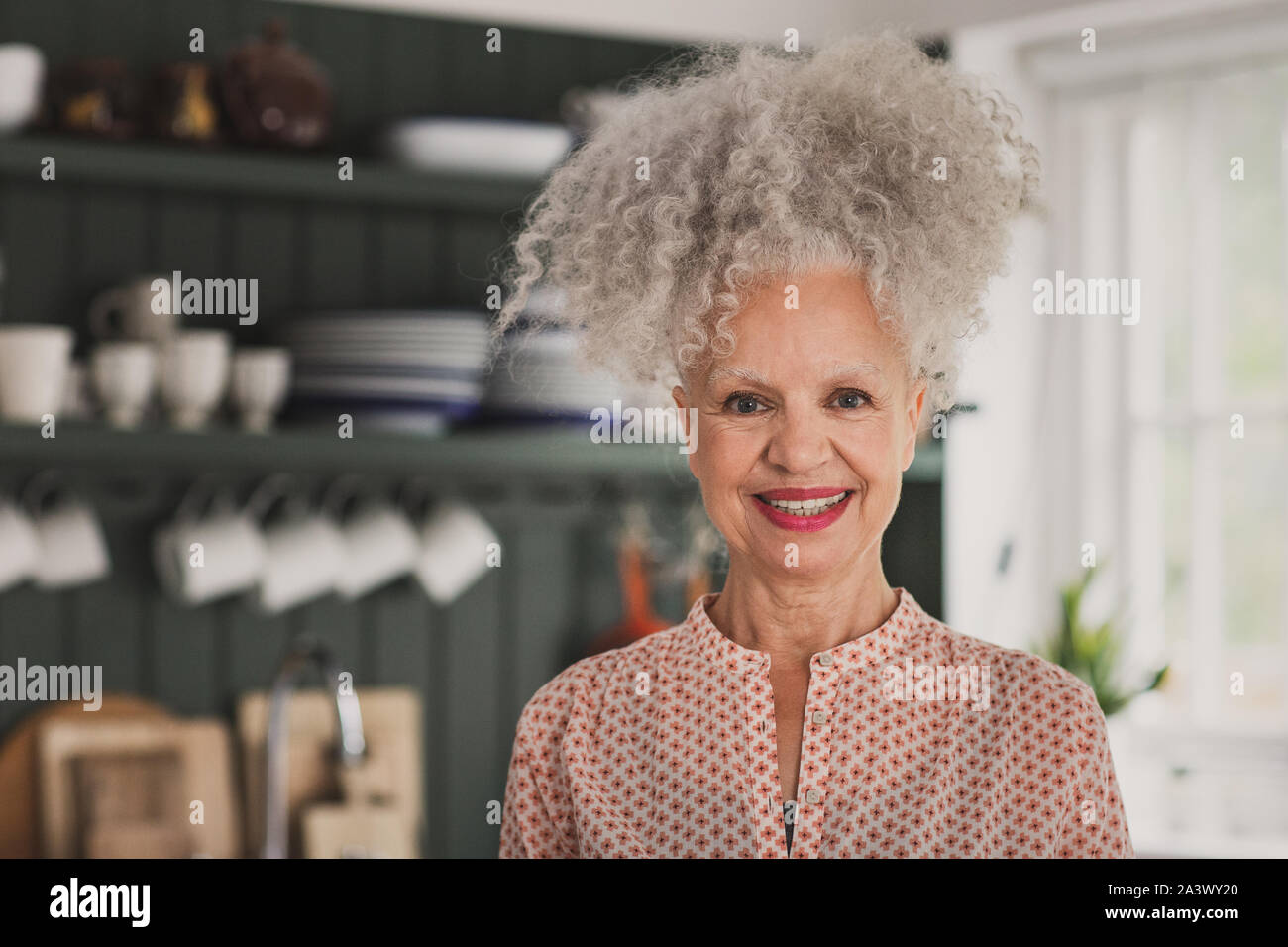 Portrait of mixed race senior adult woman at home Stock Photo