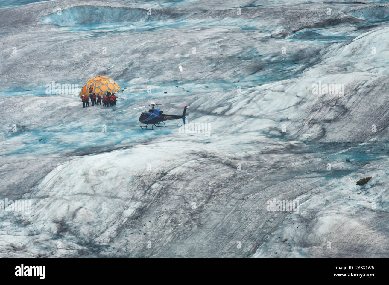 Helicopter And A Group Of Hikers On Mendenhall Glacier, Juneau, AK Stock Photo