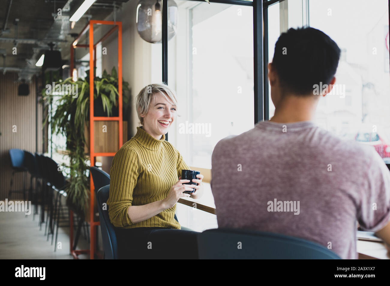 Friends having coffee together in a cafe Stock Photo