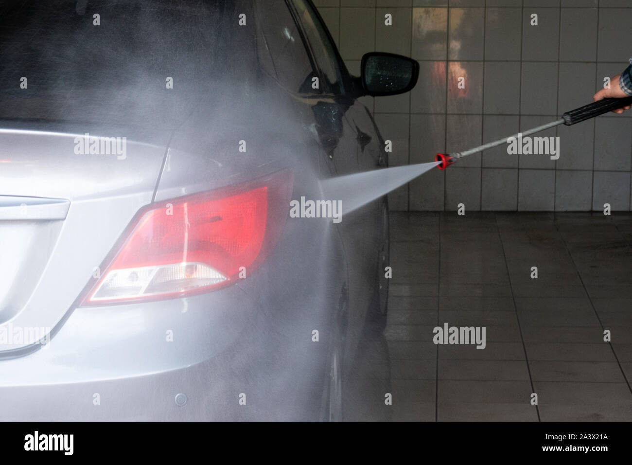 Gray car wash with water at a car wash. Contactless sink. Car wash