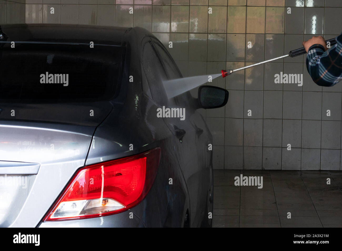 Gray car wash with water at a car wash. Contactless sink. Car wash
