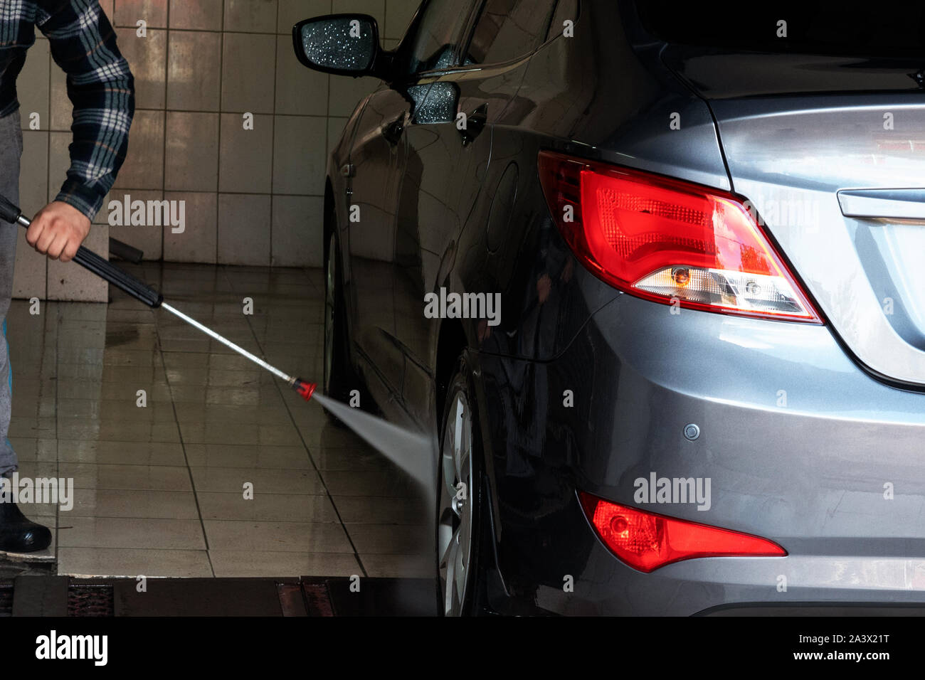 Gray car wash with water at a car wash. Contactless sink. Car wash