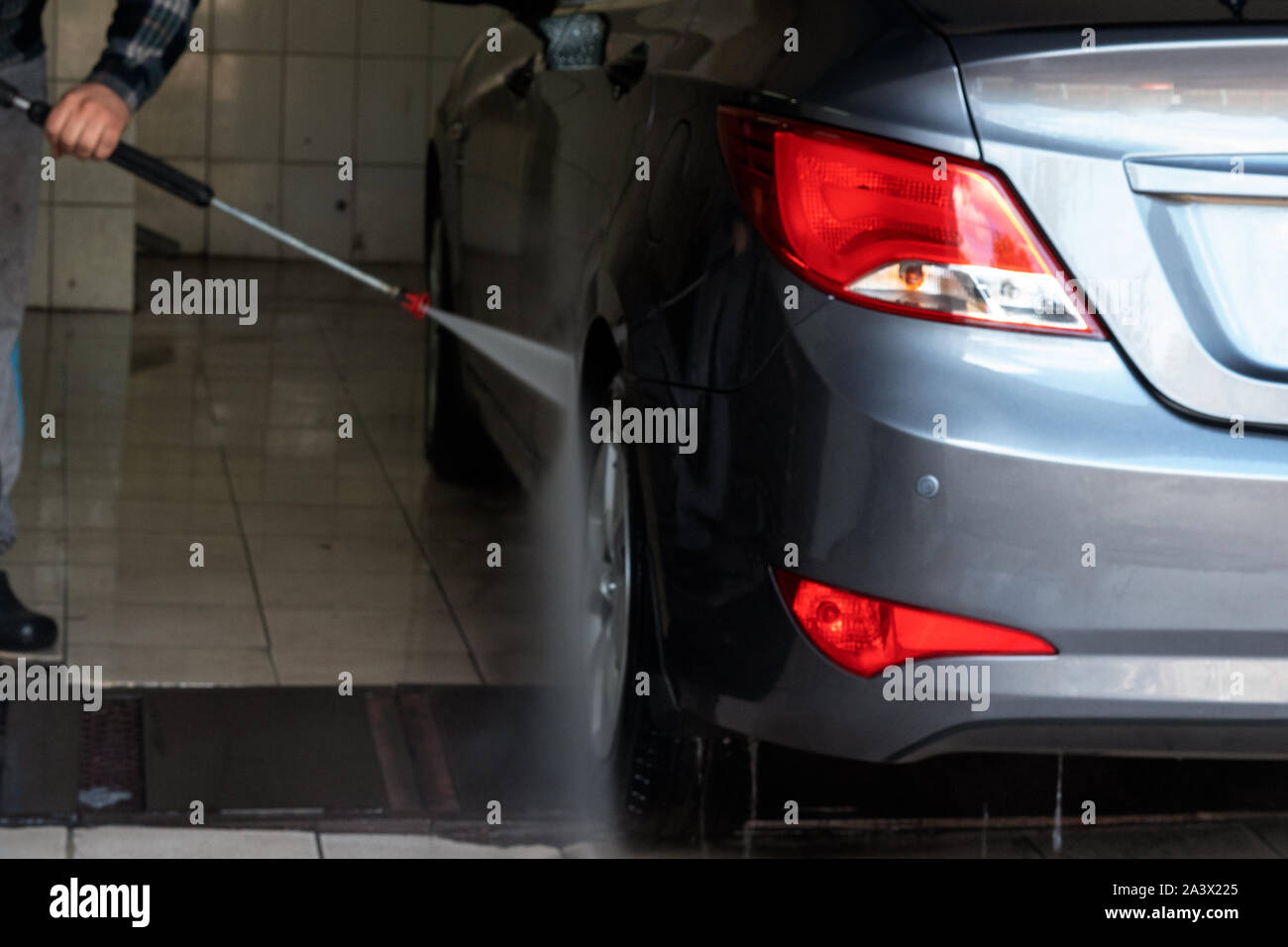 Gray car wash with water at a car wash. Contactless sink. Car wash