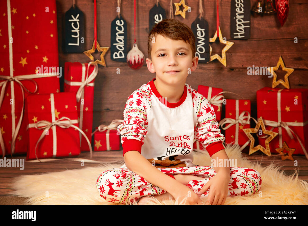 happy cute boy 10 years old on the floor in pajamas waiting for the new year and happy christmas Stock Photo Alamy