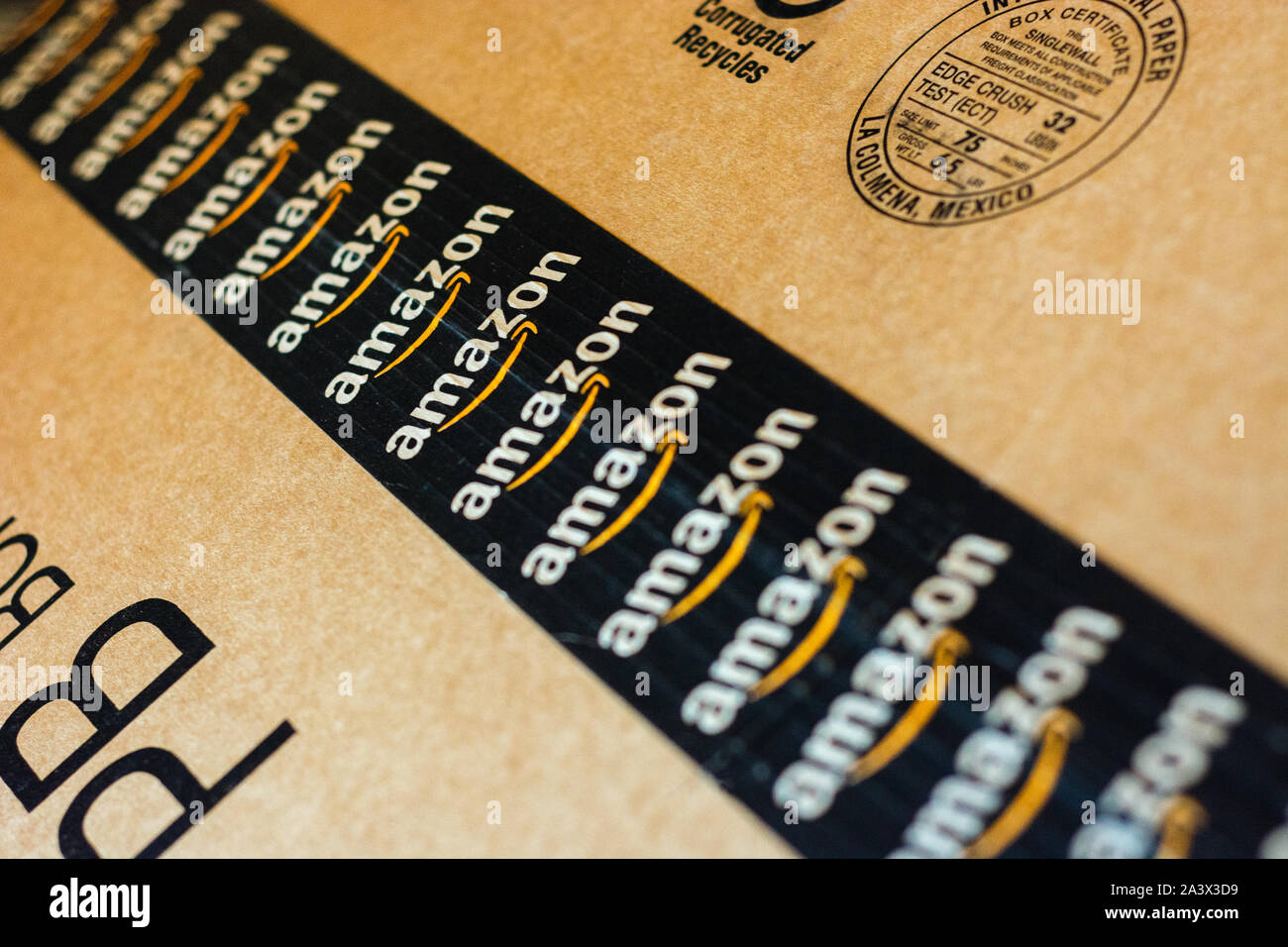 Monterrey, Mexico - Sept 3,0 2019: Amazon standard shipping box. Amazon logotype printed on cardboard box security scotch tape. Stock Photo