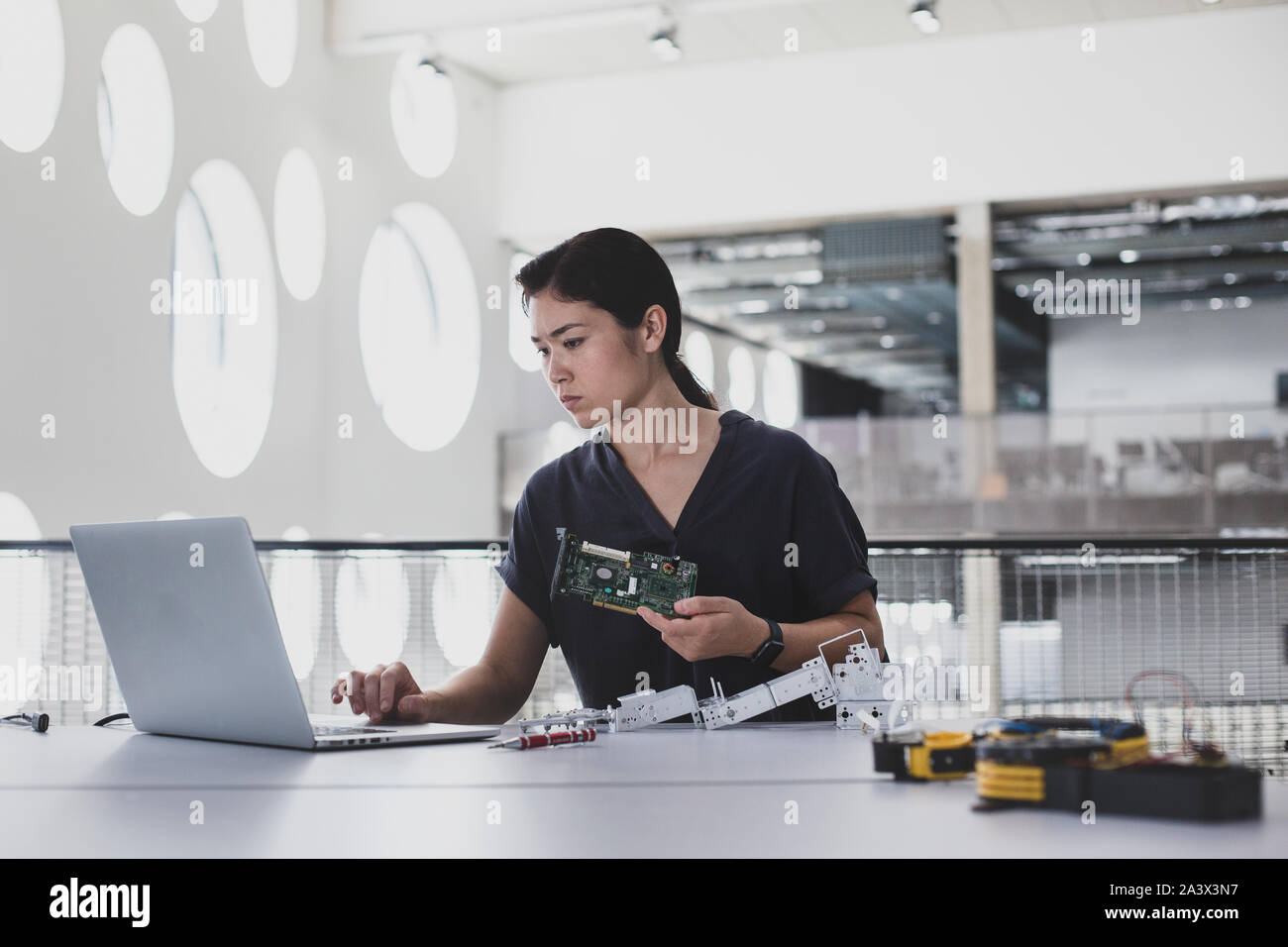 Female working on robotics Stock Photo