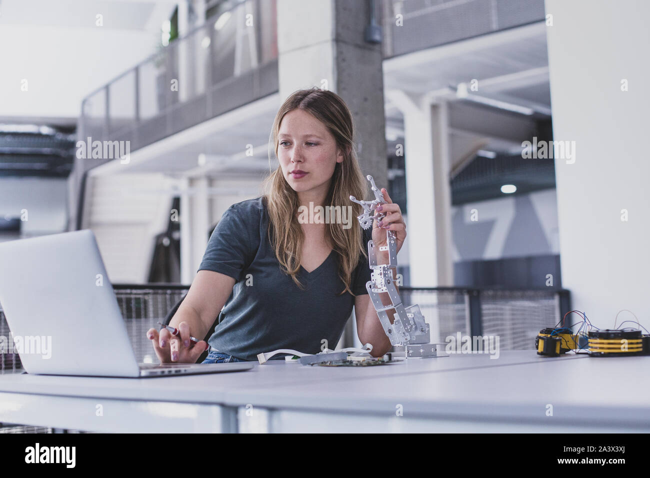 Female working on robotics Stock Photo