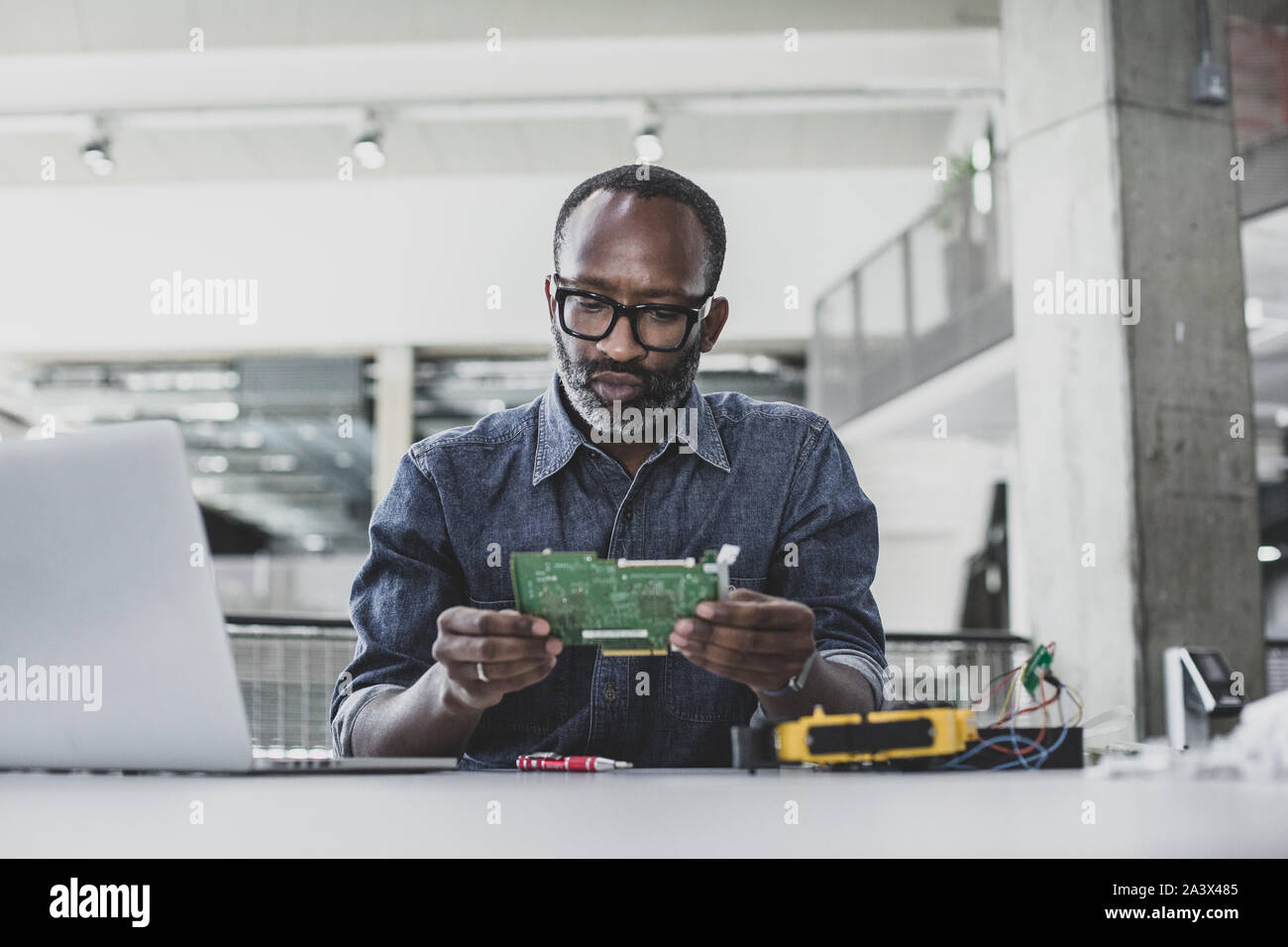African American adult male working on robotics Stock Photo