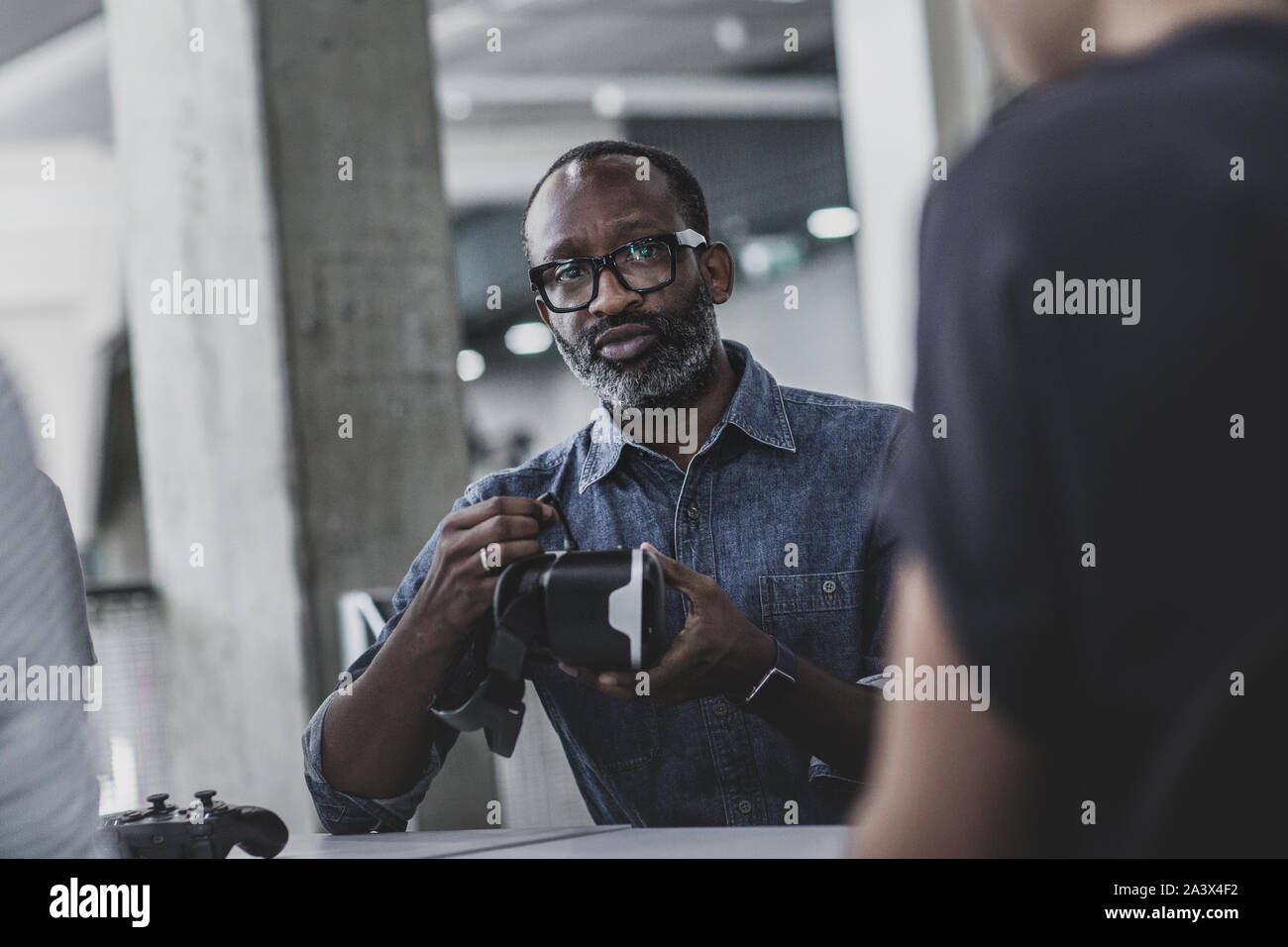 African American male game designer leading a meeting Stock Photo