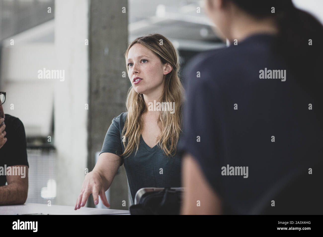 Female game designer leading a meeting Stock Photo
