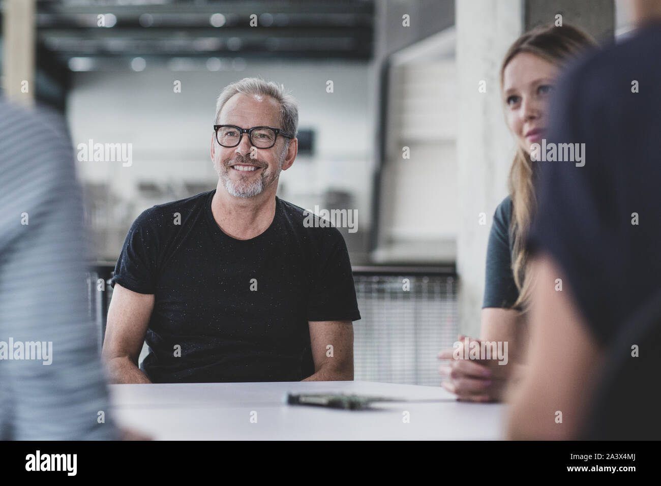 Mature adult male leading a meeting at a tech company Stock Photo