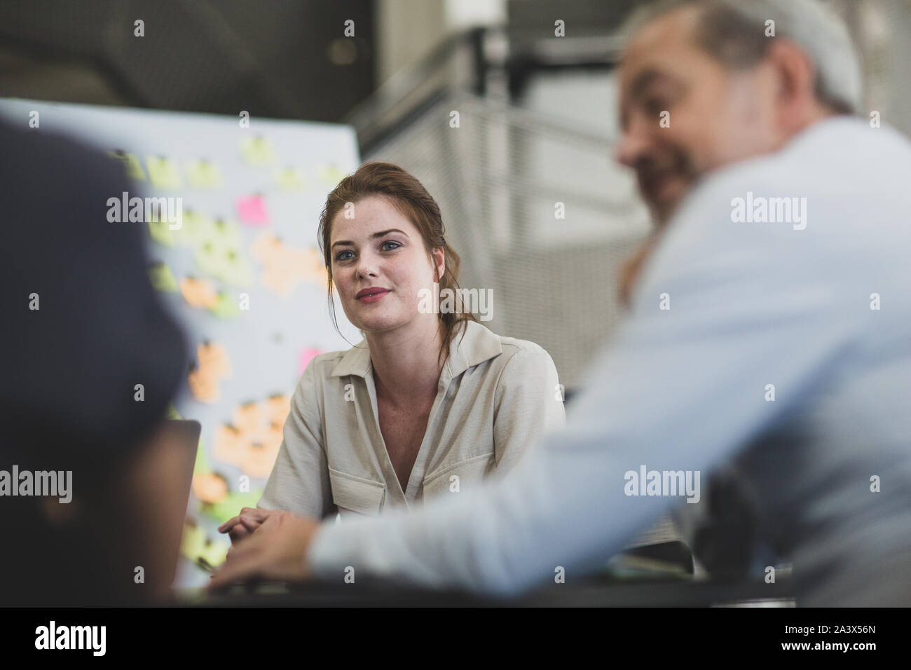 Female executive listening in a brainstorm meeting Stock Photo