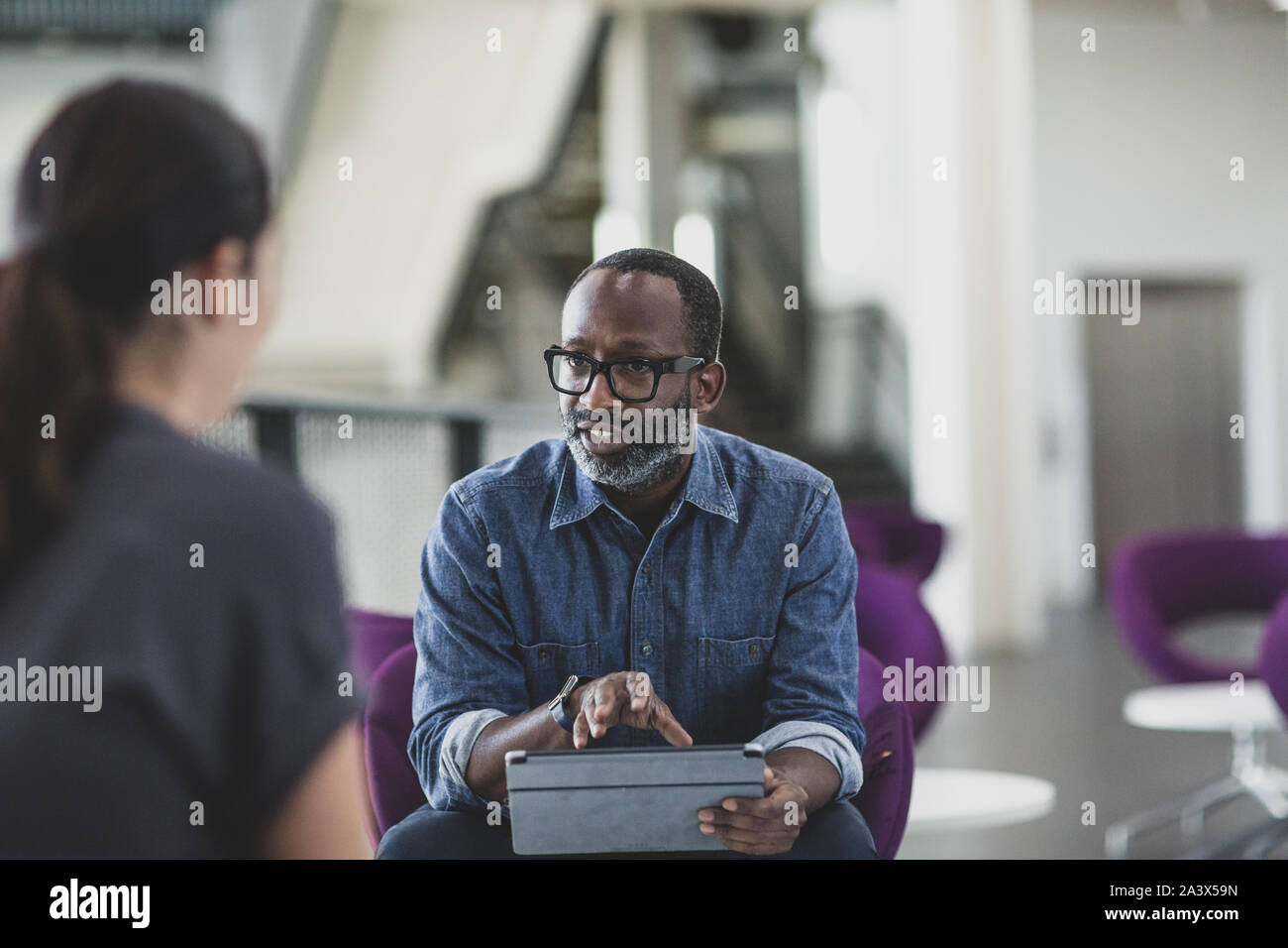 African American businessman using a digital tablet in a meeting Stock Photo