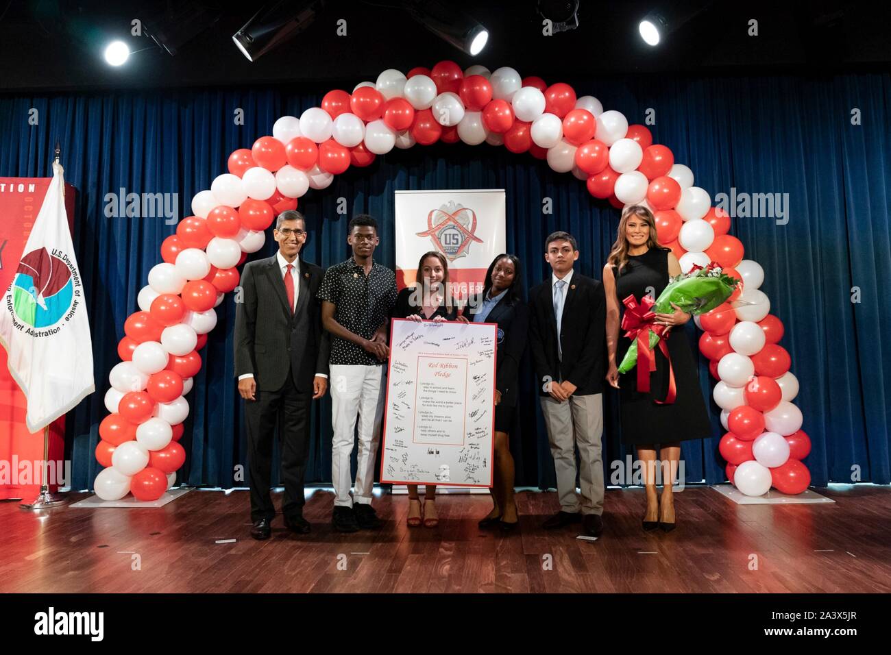 U.S First Lady Melania Trump, right, and Drug Enforcement Agency Administrator Uttam Dhillon, left, poses for a photo with high school students during the National Red Ribbon Rally at the Drug Enforcement Agency Headquarters October 7, 2019 in Washington, DC. Stock Photo