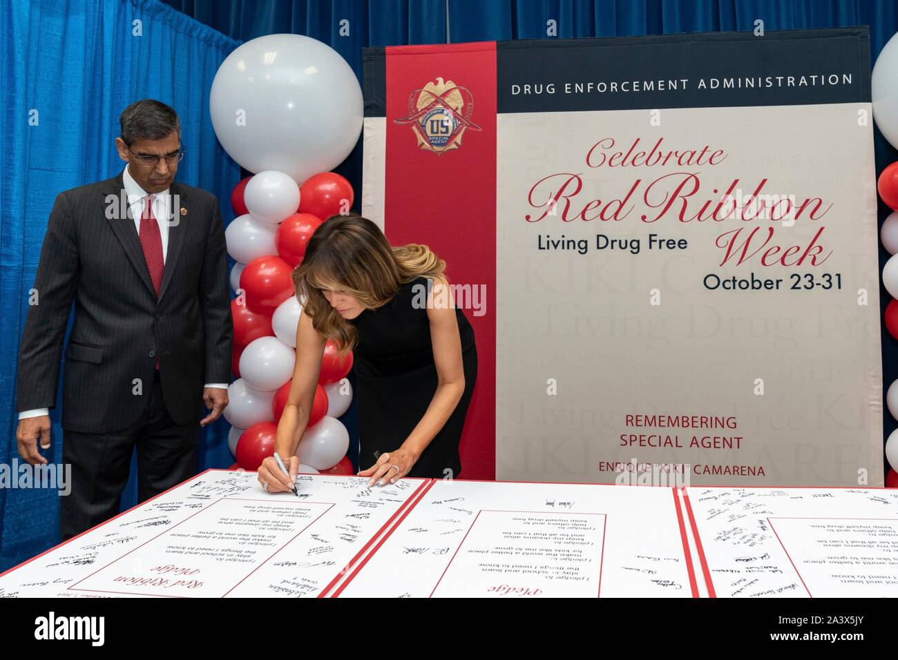 U.S First Lady Melania Trump and Drug Enforcement Agency Administrator Uttam Dhillon, left, sign the Red Ribbon Pledge, at the Drug Enforcement Agency Headquarters October 7, 2019 in Washington, DC. Stock Photo