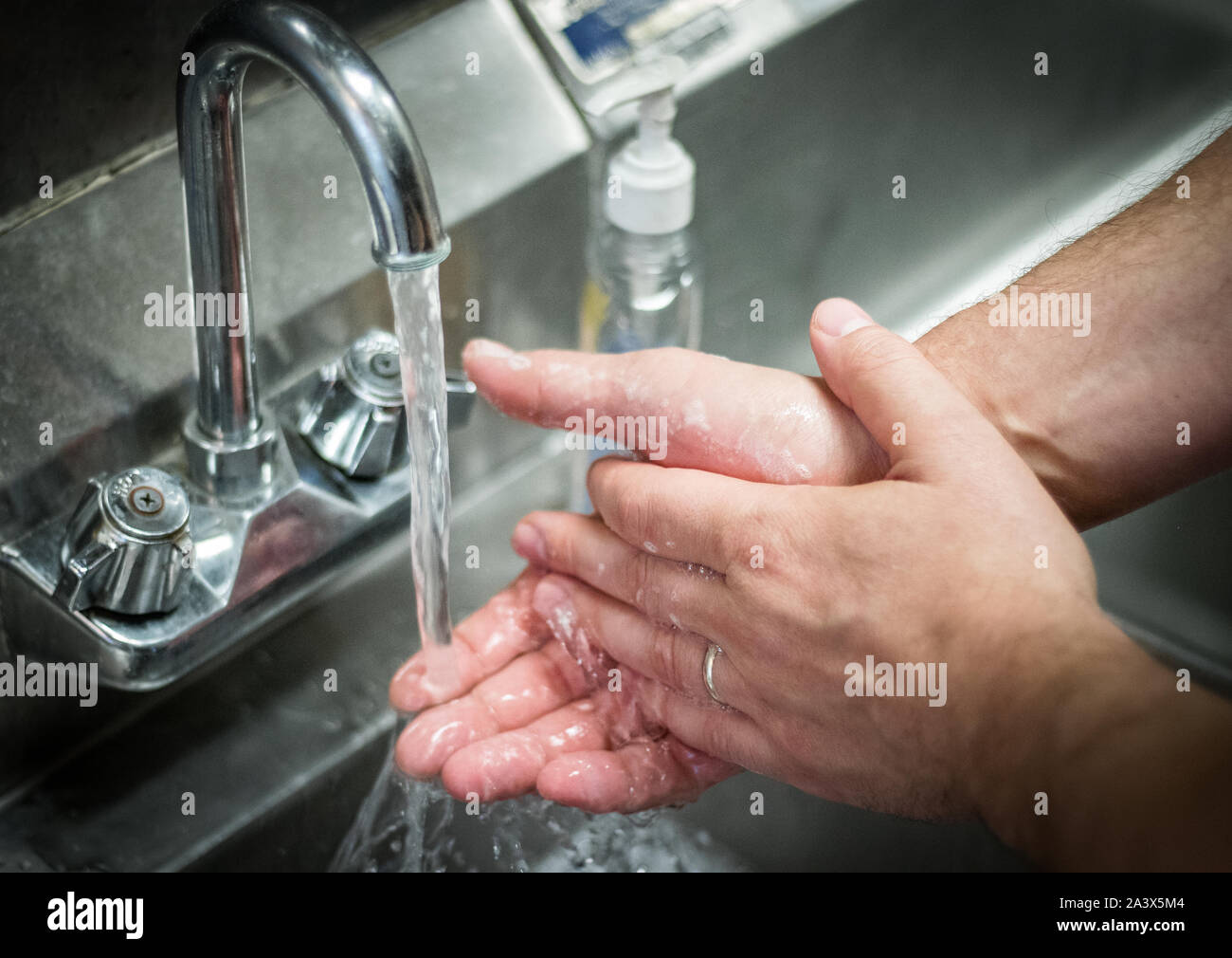 Handwashing hands; washing with soap and water at stainless steel sink