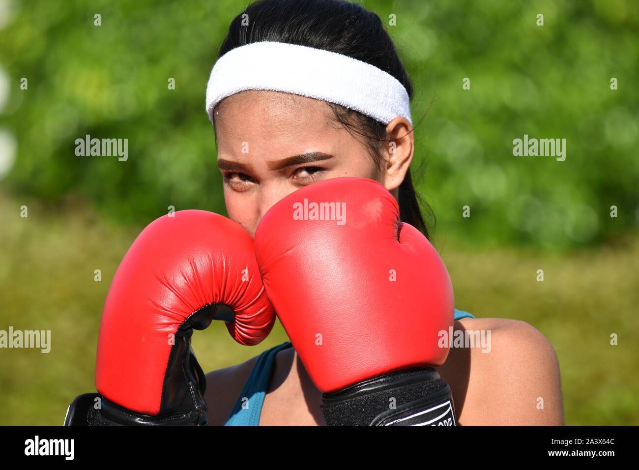 Young athlete boxing the punching bag outside in austria wall