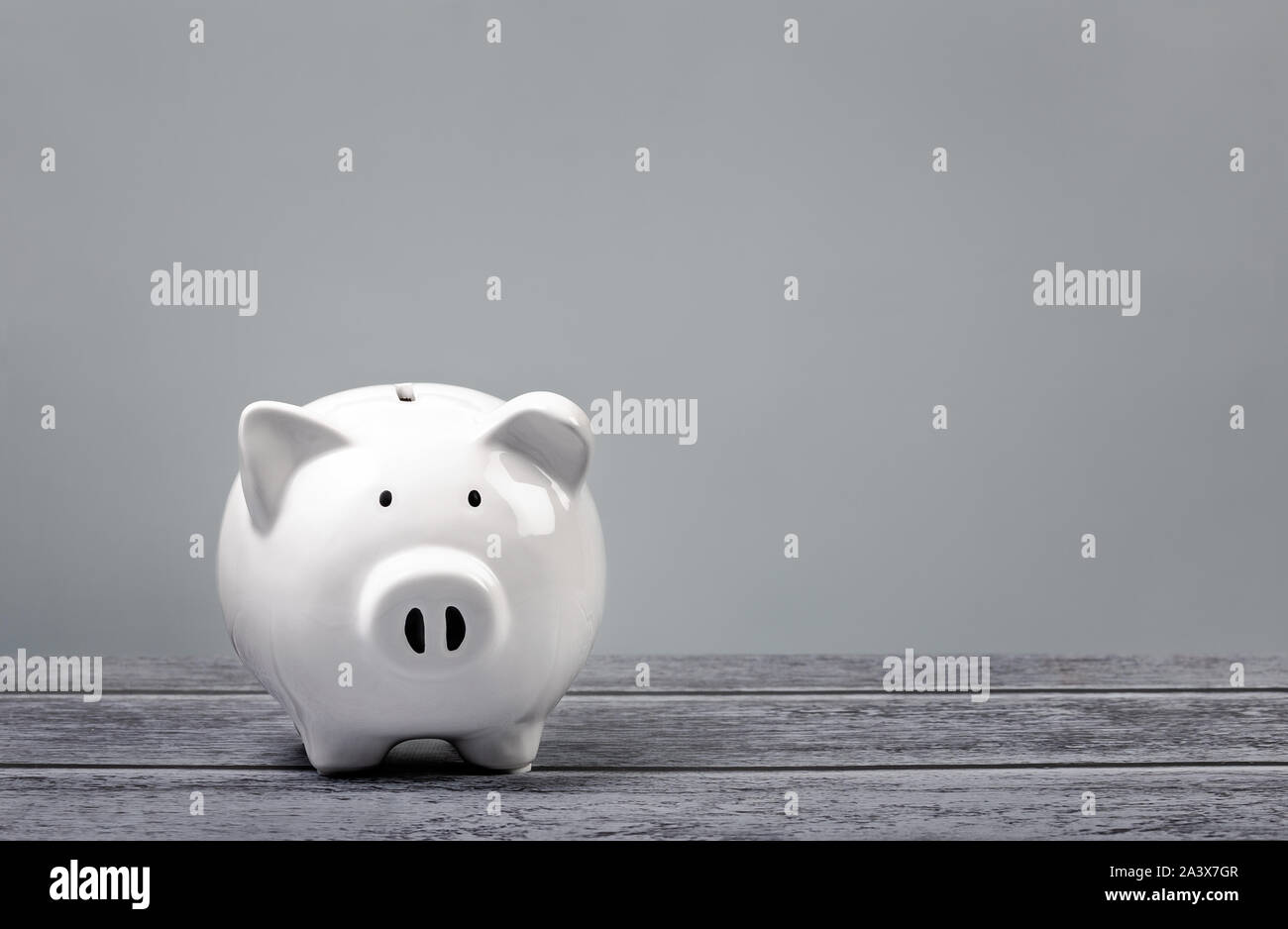 Cute white Piggy Bank over a blue and grey background. Stock Photo