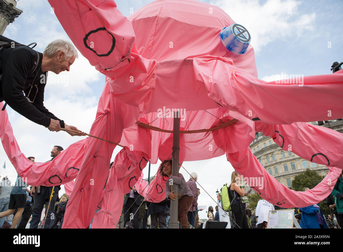 Westminster, London, UK. 10 October 2019. Environmental campaigners Extinction Rebellion have started two weeks protests from 7th to 20th October in and around London to demonstrate against climate change. The protesters in Trafalgar Square demand decisive action from the UK Government on the global environmental crisis. The controversial pink Octopus is moved around in the square. Stock Photo