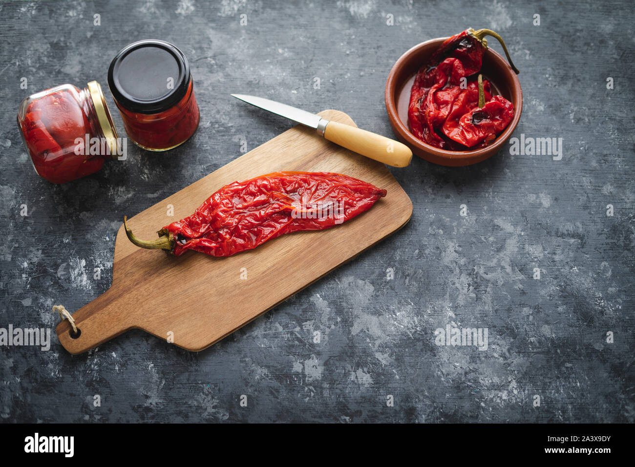 Preparing roasted red peppers for packaging. Stock Photo