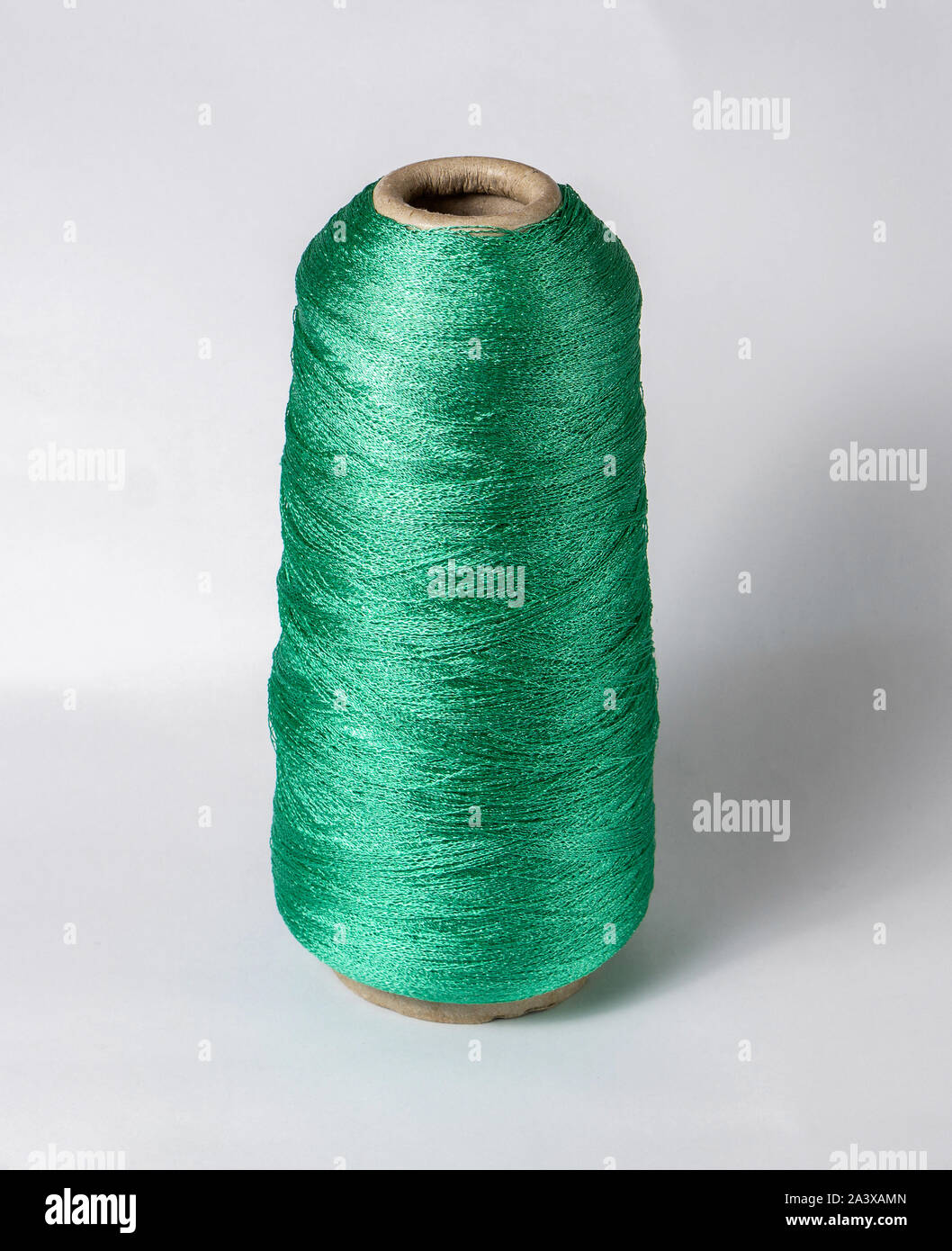 bobbin of yarn on a white background. Side view.Textile reel on