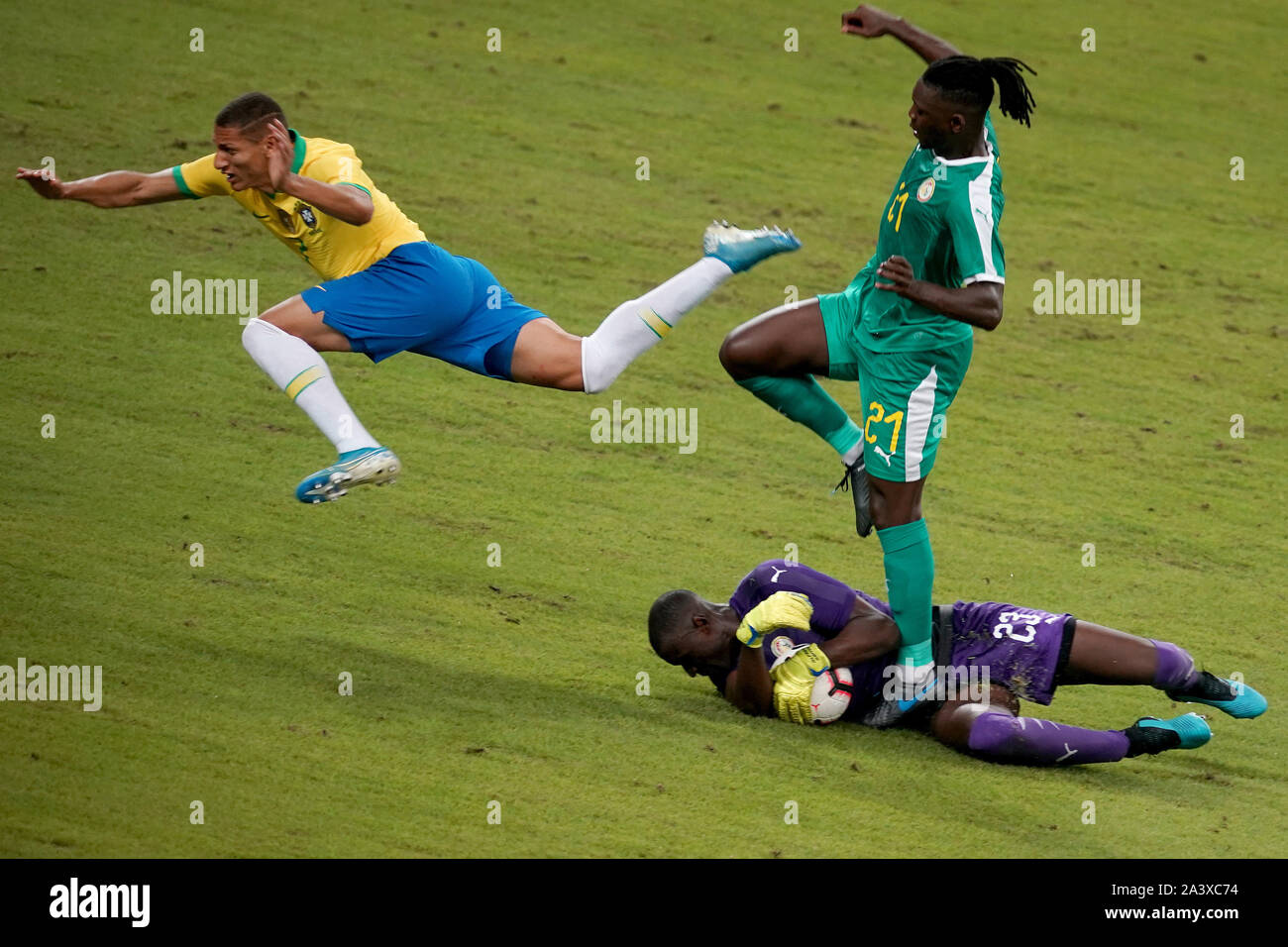 National Stadium Singapore, Singapore. 10th Oct, 2019. International Friendly, Brazil versus Senegal; Richarlison of Brazil leaps over the challenge from Lamine Gassama and leaves the ball for keeper Alfred Gomis of Senegal - Editorial Use Credit: Action Plus Sports/Alamy Live News Stock Photo