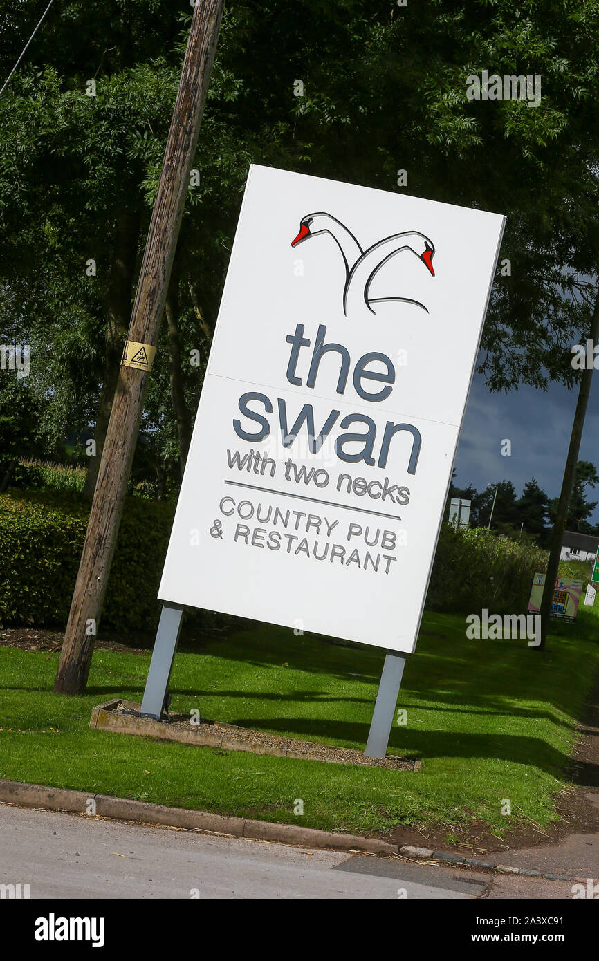 A sign outside The Swan with Two Necks pub or public house, Blackbrook, Newcastle under Lyme, Staffordshire, England, UK Stock Photo