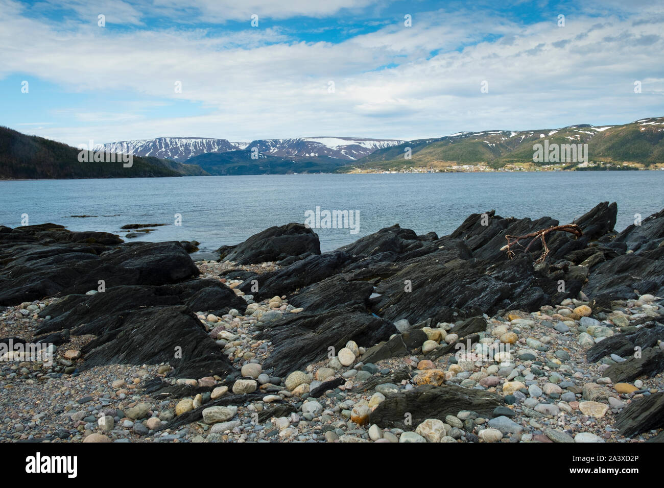 Beach at Norris Point with view across the fjord of the Tablelands and Gros Morne National Park, Newfoundland Stock Photo
