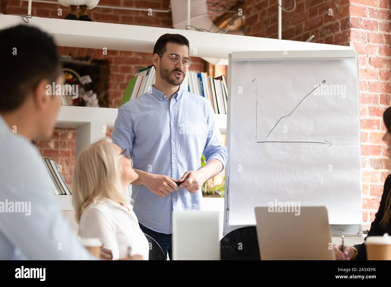 Male presenter making flipchart presentation at briefing Stock Photo