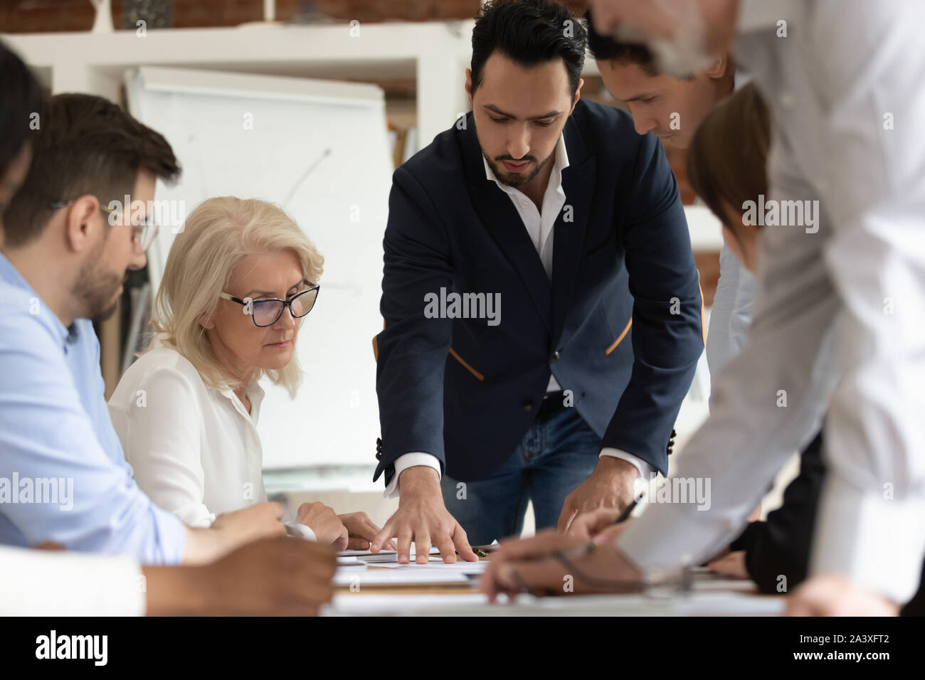 Diverse employees brainstorm discussing project at briefing Stock Photo