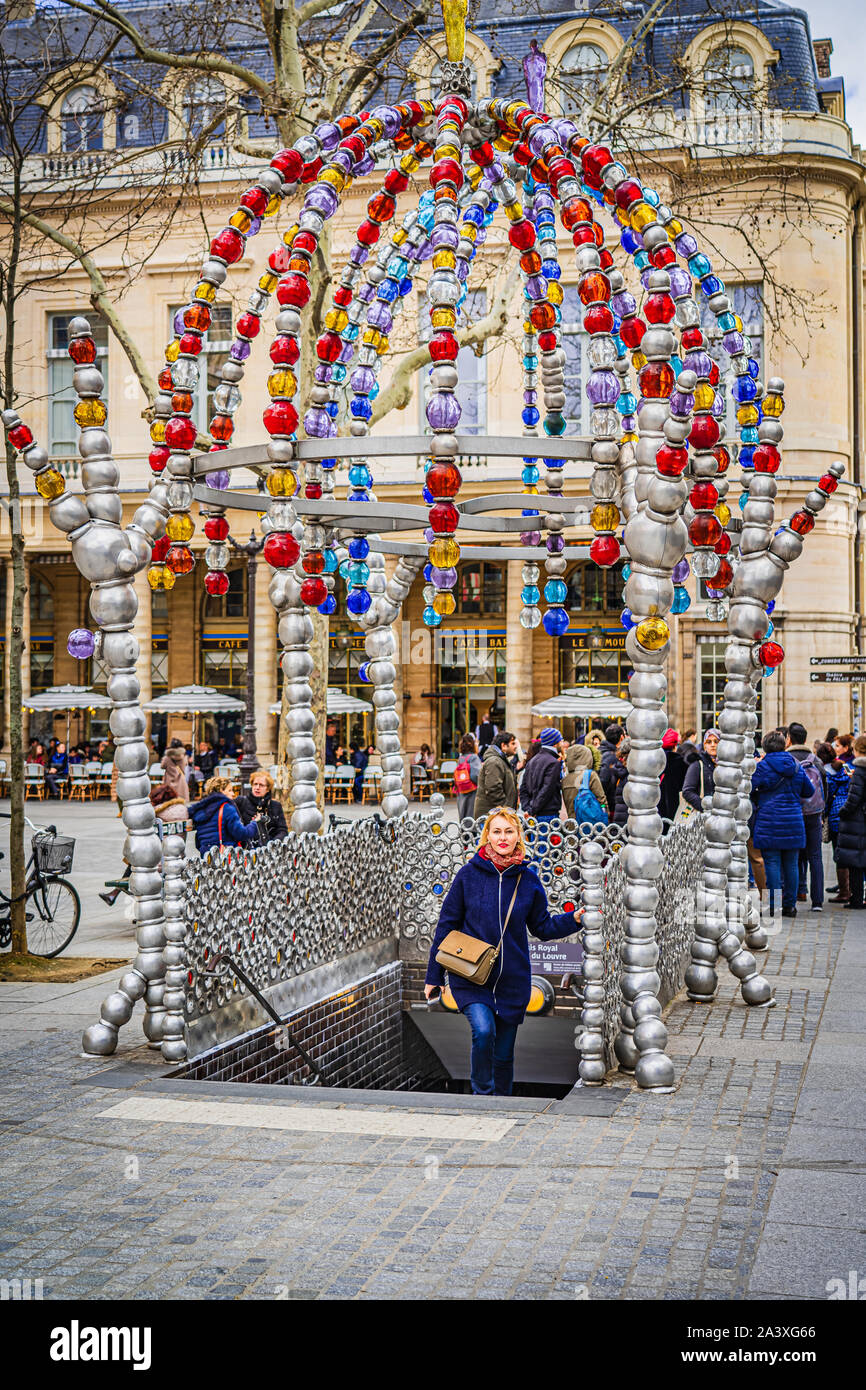 shot of a lady coming out of the subway to find a beutiful art instalation above Stock Photo