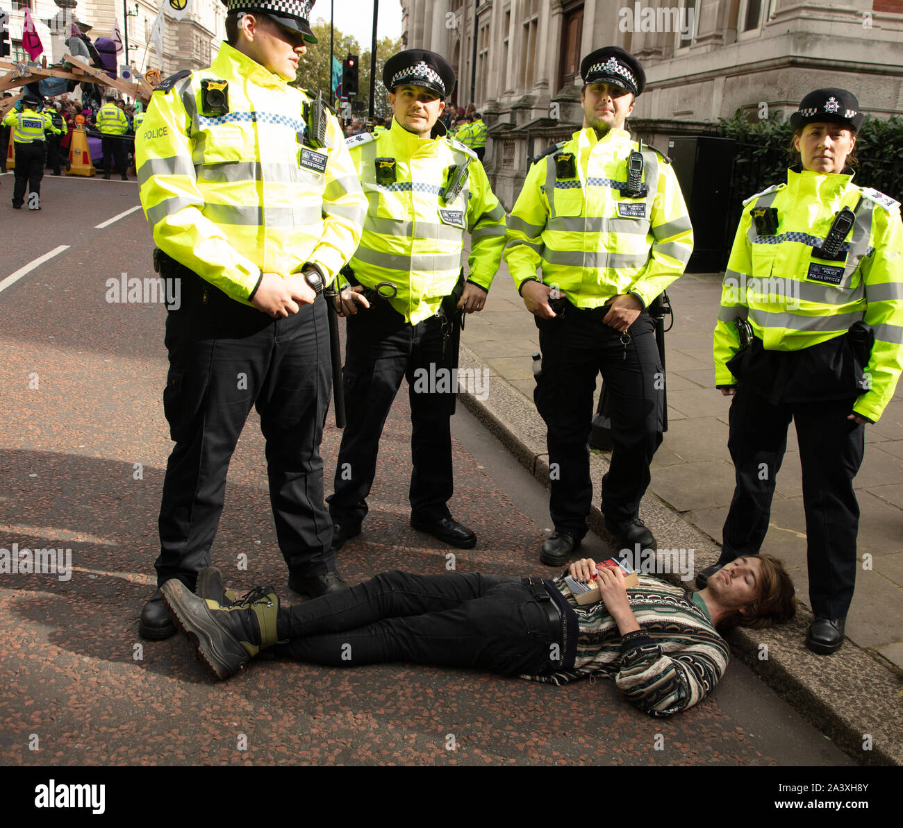 London, UK. 9th October 2019. Police arrest a protester in Birdcage Walk, Westminster, during the Extinction Rebellion two week long protest in London. Credit: Joe Kuis / Alamy News Stock Photo