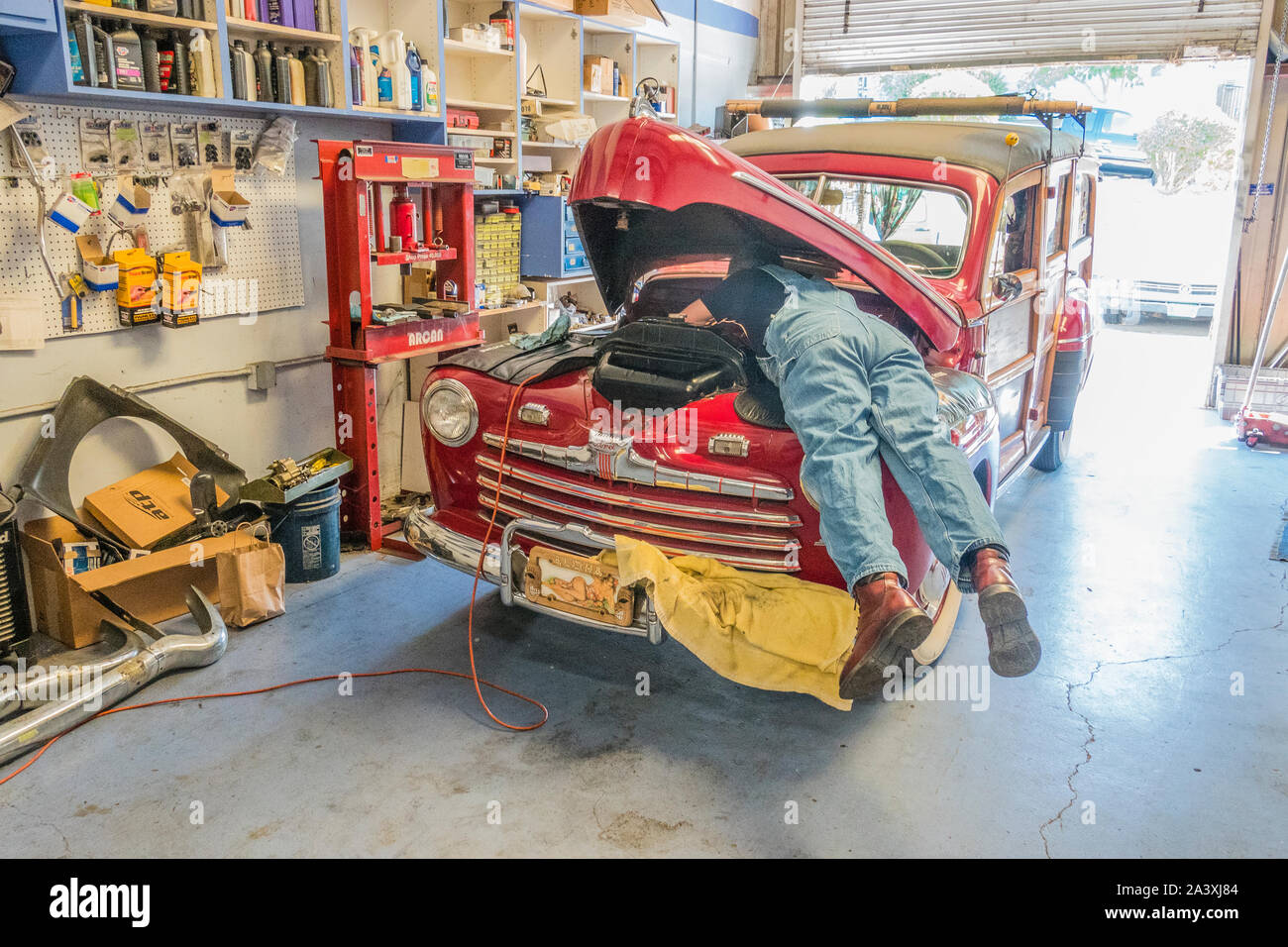 Car repairman under hood Stock Photo