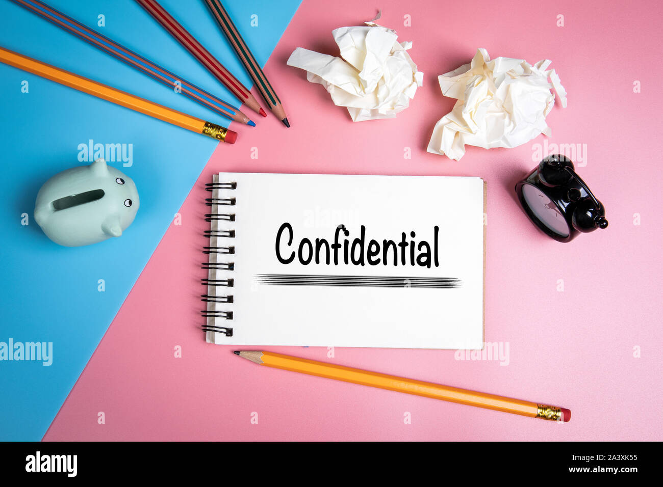 Confidential concept. Handwriting text in the notebook. Savings box and stationery Stock Photo