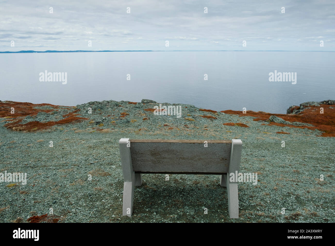 Looking out to sea from a bench in Goose Cove at the tip of the Great Northern Peninsula in Newfoundland Stock Photo