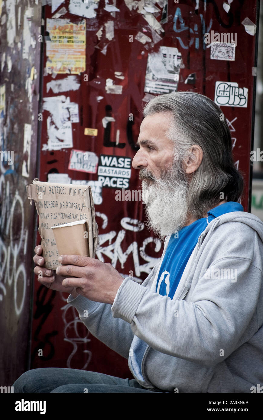 Athens, Greece. 10th Oct, 2019. A homeless person sits on the sidewalk ...