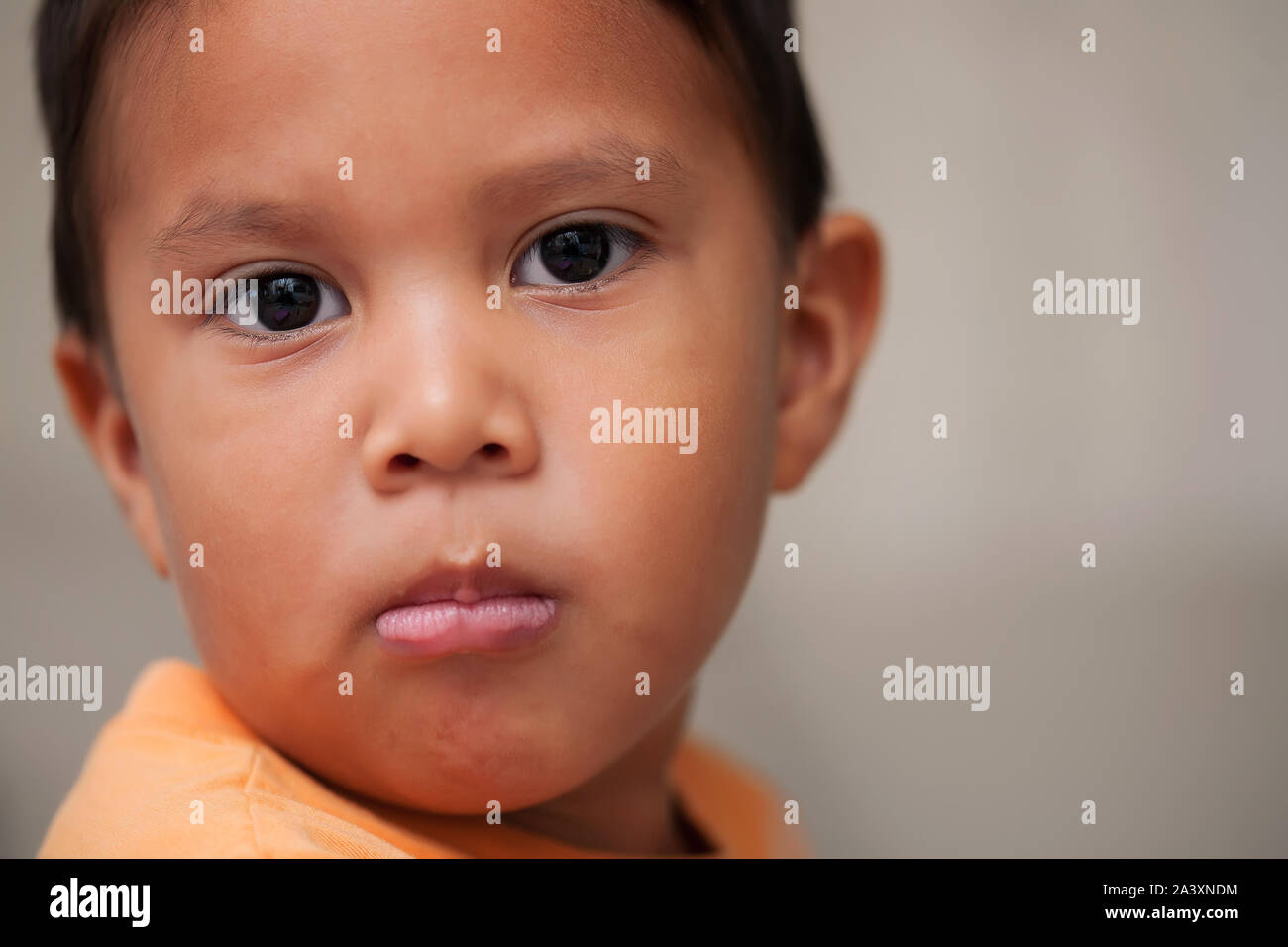 An upset look, facial expression or long face by a little boy that has been reprimanded for bad behavior. Stock Photo