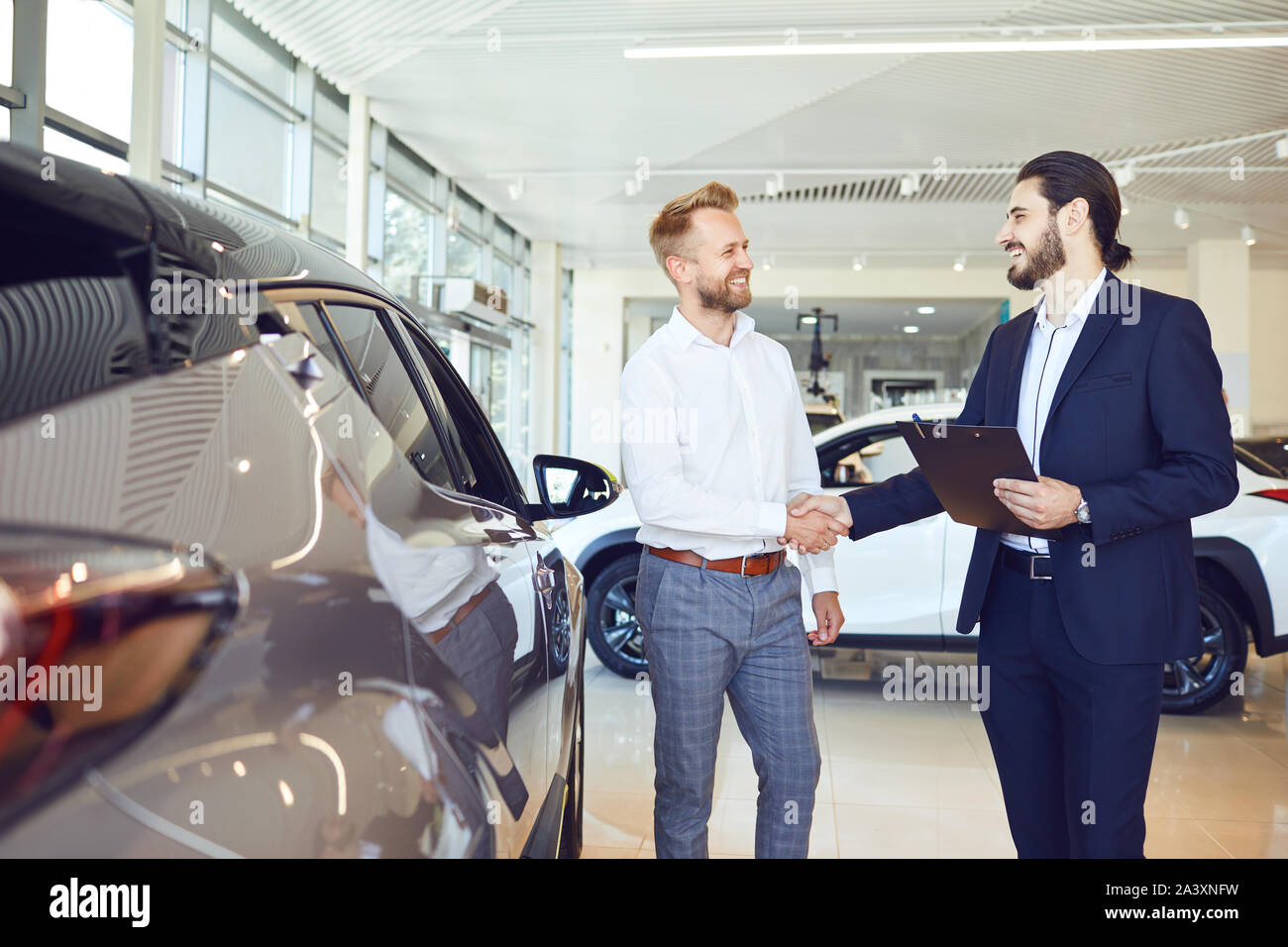Auto business. The buyer and seller of cars make a handshake Stock Photo