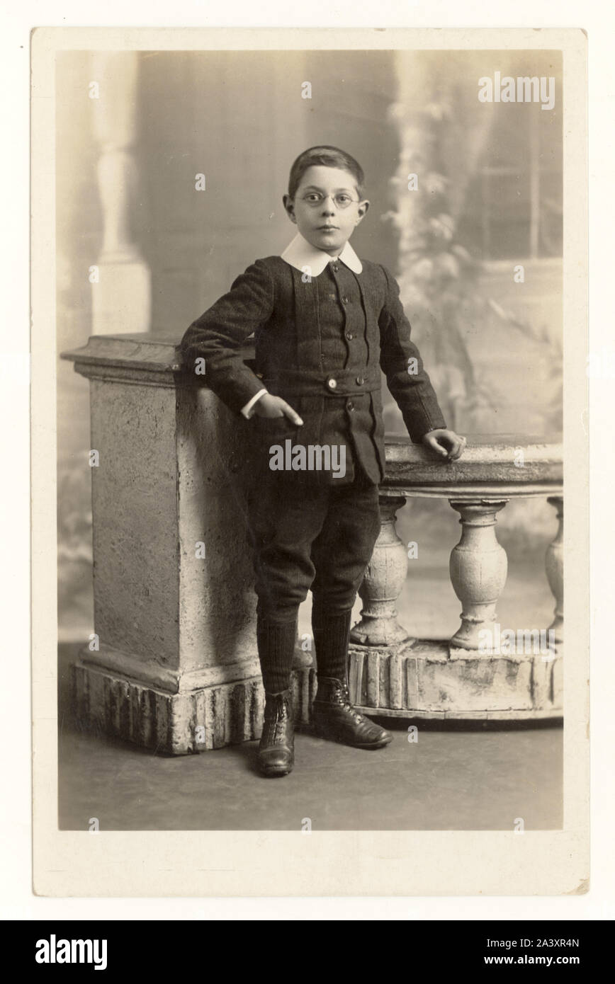 Early 1900's WW1 era postcard of young boy wearing glasses, smart suit, breeches, big collar, London, dated on reverse June 1914, U.K Stock Photo