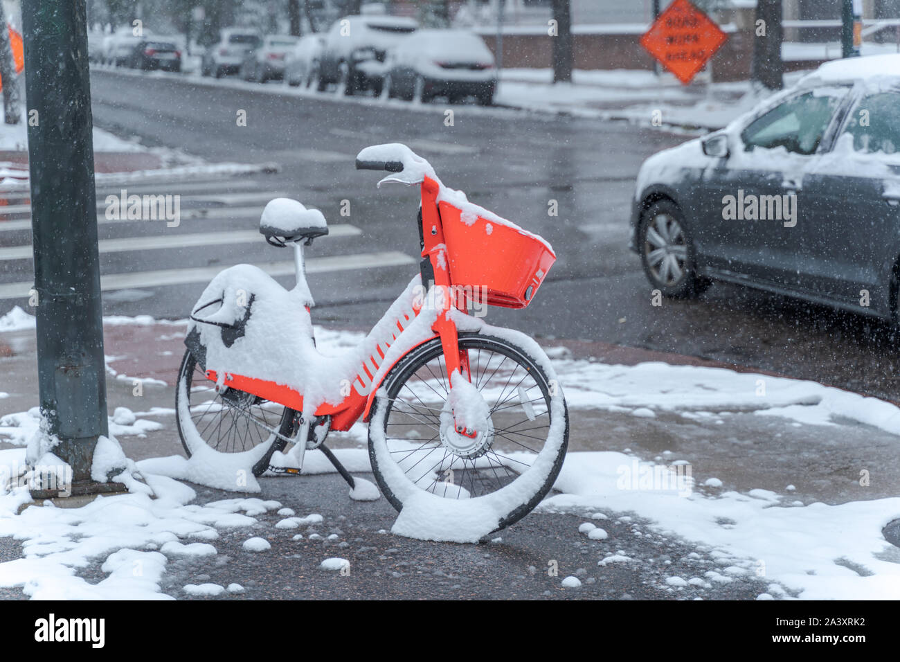 Denver, Colorado, USA- October 10, 2019: e-bicycle during Denver's first snow storm of the season. Stock Photo
