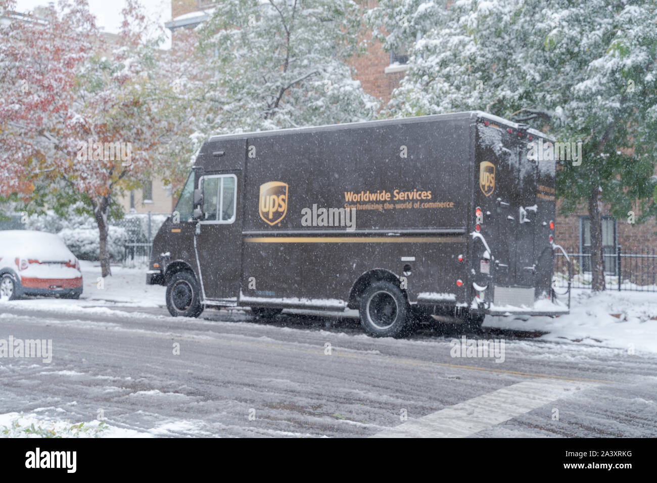 Denver, Colorado, USA- October 10, 2019: UPS delivery truck during Denver's first snow storm of the season. Stock Photo